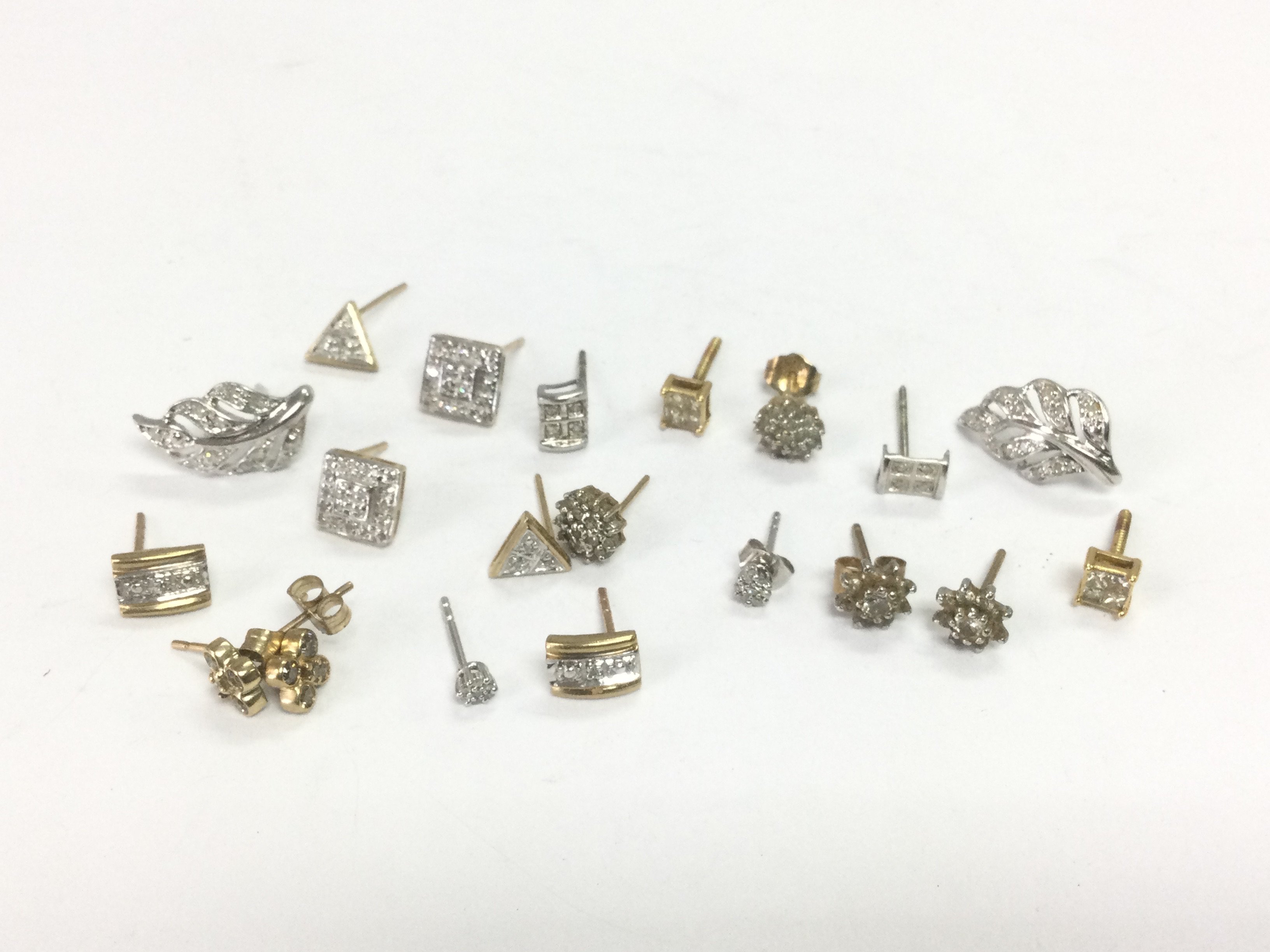 A collection of gold diamond cluster studs, total approx 9.7g. Shipping category A.
