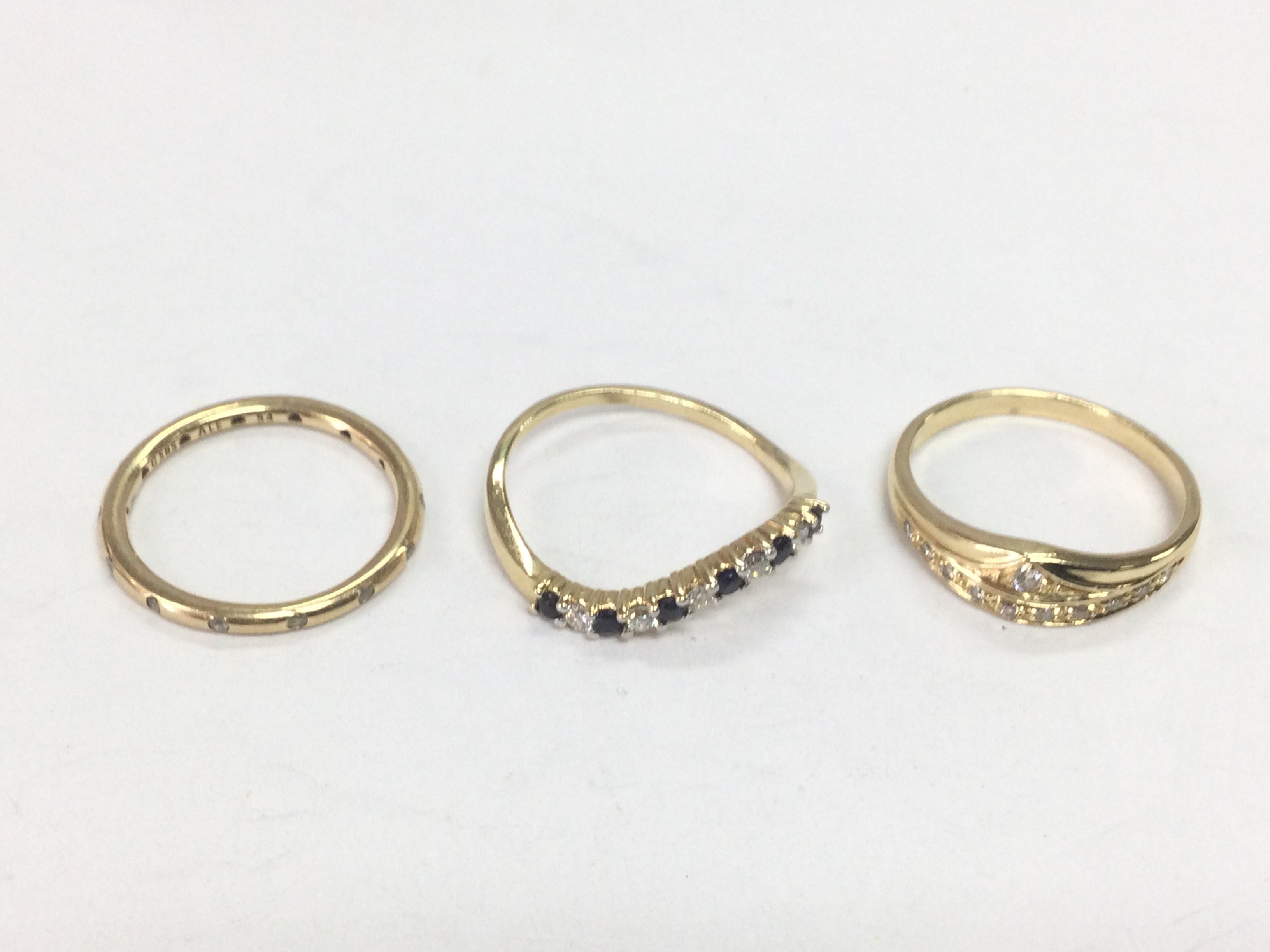 Three 14ct gold rings, one set with diamonds and sapphires and two with diamonds, approx sizes N.O and P. Total approx 6.7g. Shipping category A.