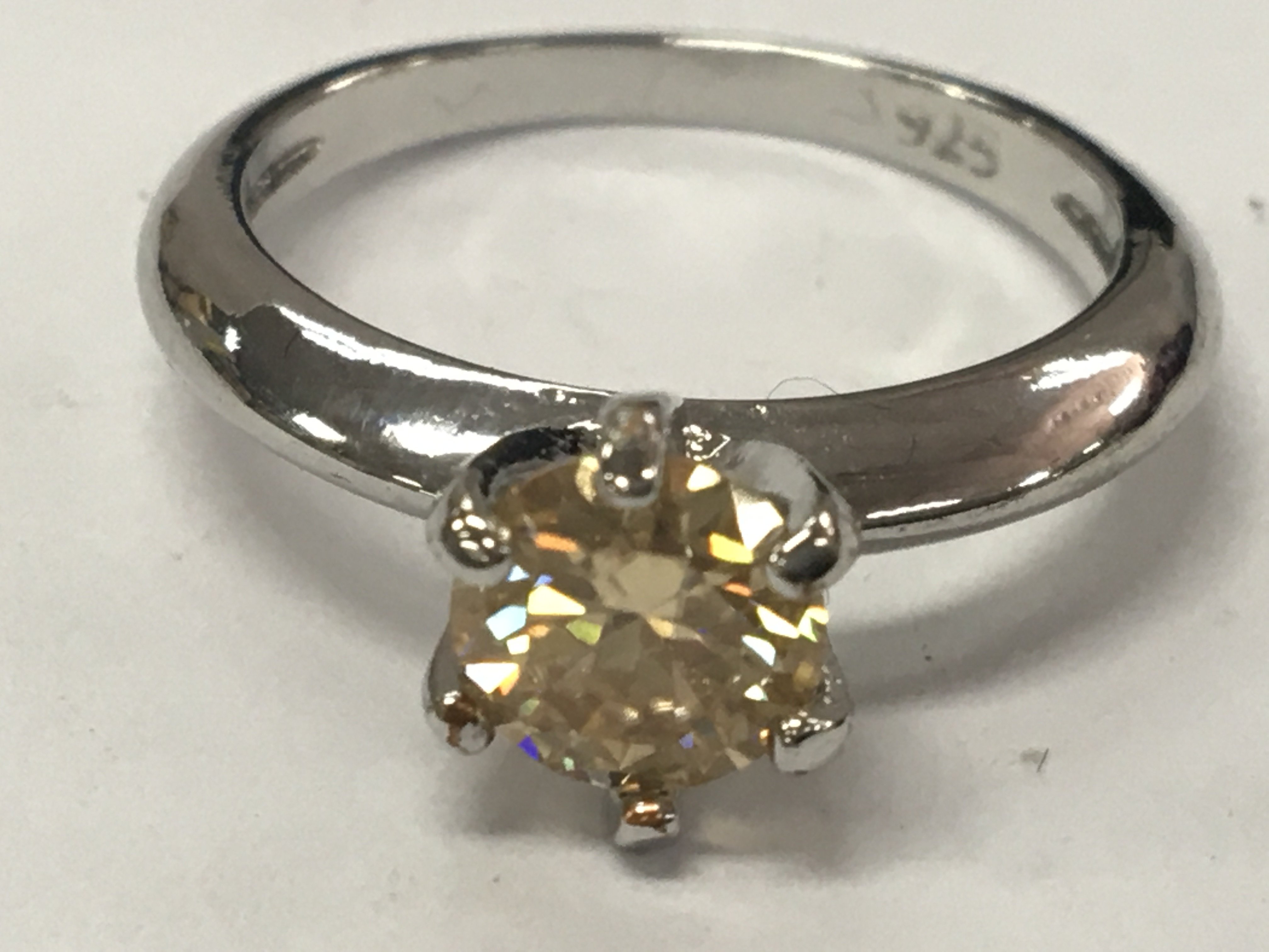 A 1ct Moissanite champagne solitaire ring with GRA report. Size N 1/2 in 925 silver ring.