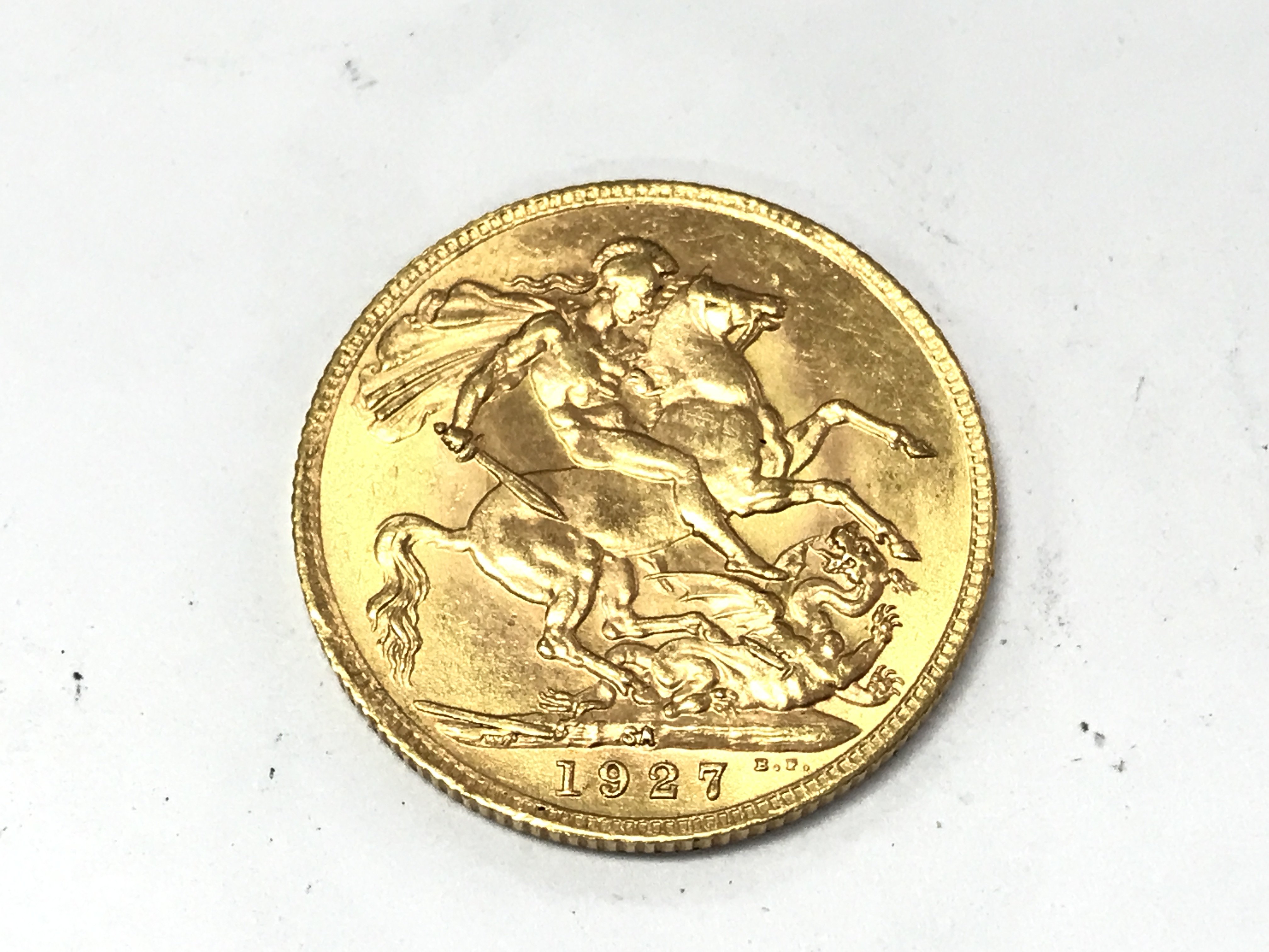 A 1927 full sovereign with South Africa mint mark. Postage A