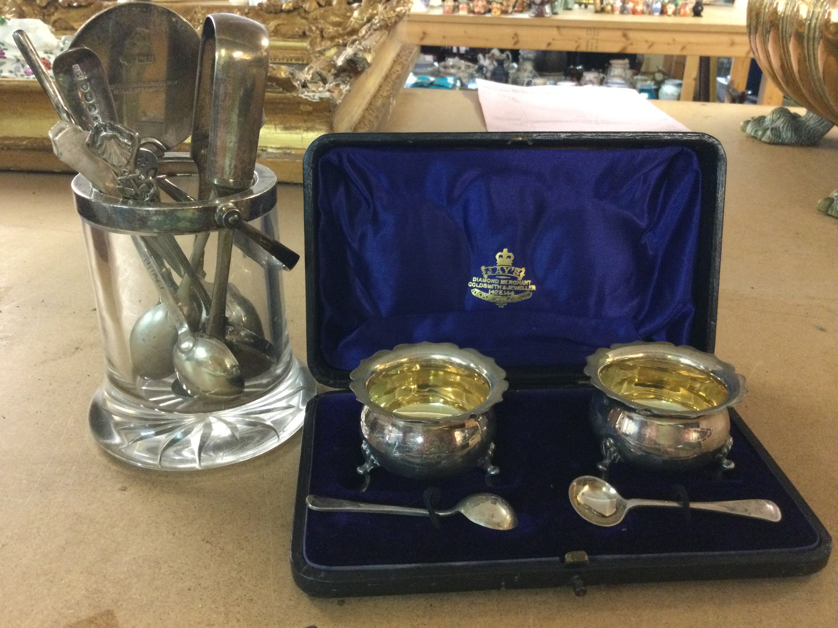 A collection of silver spoons, together with a cased cruet set, and. Glass preserve jar a silver rim
