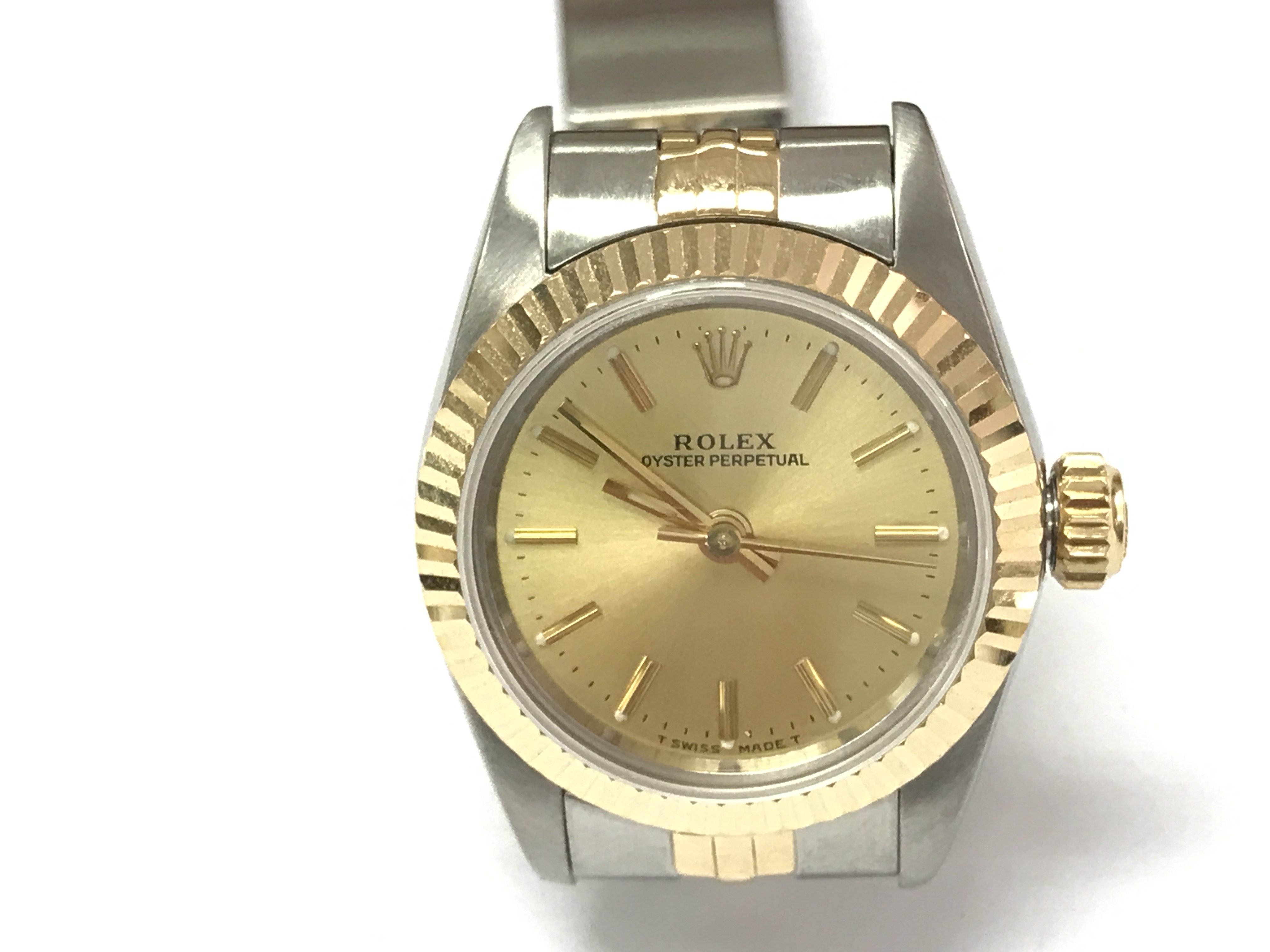 A ladies Rolex Oyster perpetual ref 67193 with gold and steel case and strap and a champagne dial. 26mm case. Watch in very good condition seen running. Comes with box and a 2010 service card. Watch circa 1991. Postage B