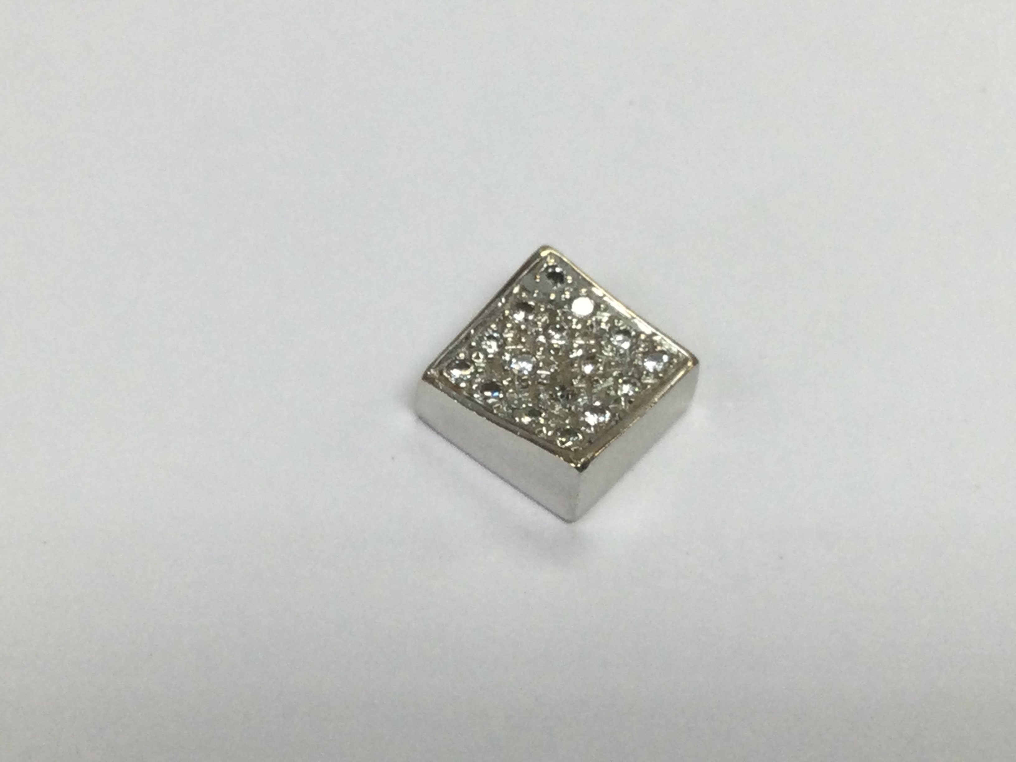 A white gold pendant set with small diamonds, approx length 2cm. Shipping category A.