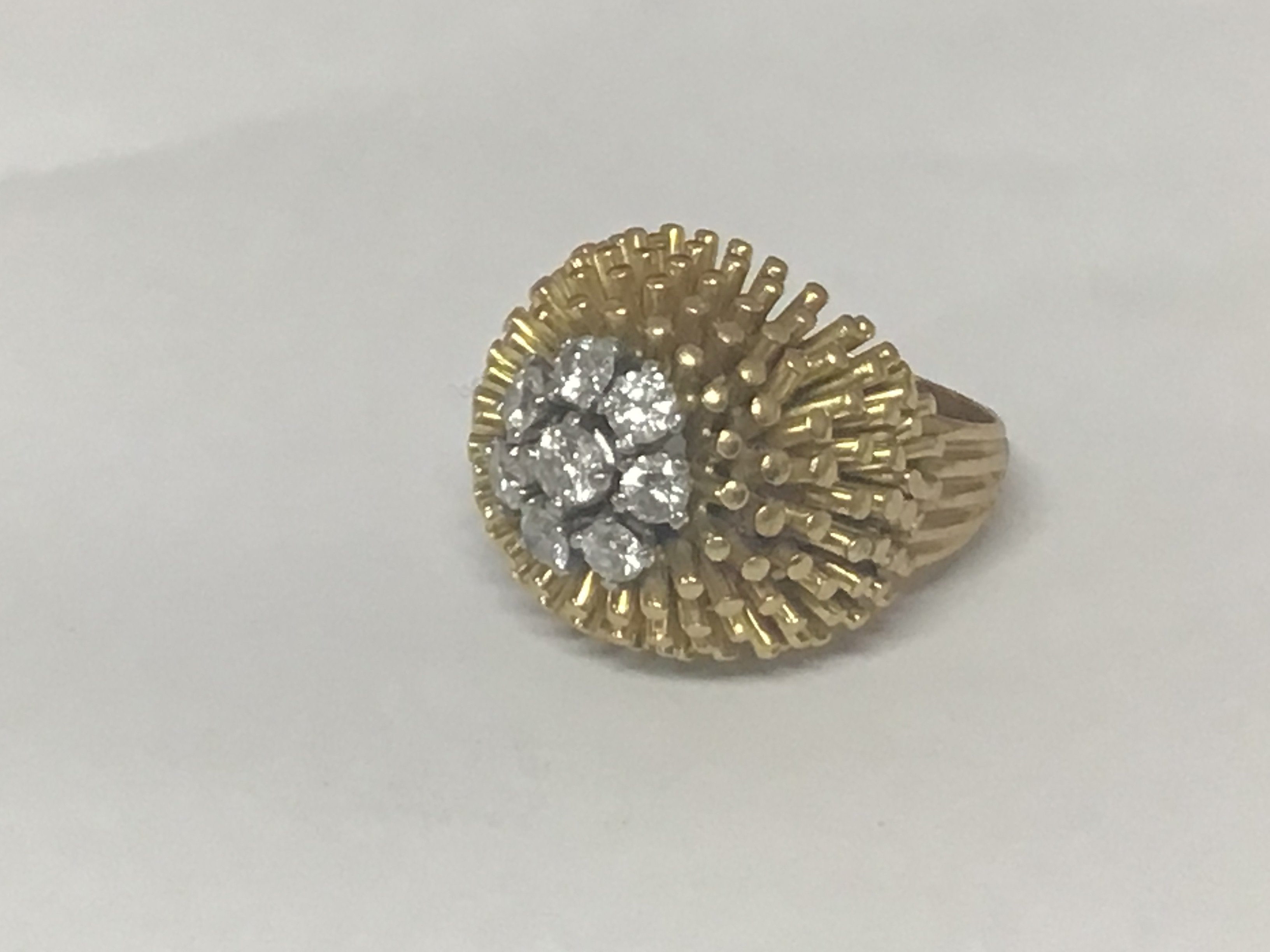 A quality 18carat yellow gold modern design ring set with a pattern of eight brilliant cut diamonds of good colour and clarity Weight 17.7g approximately ring size J-K