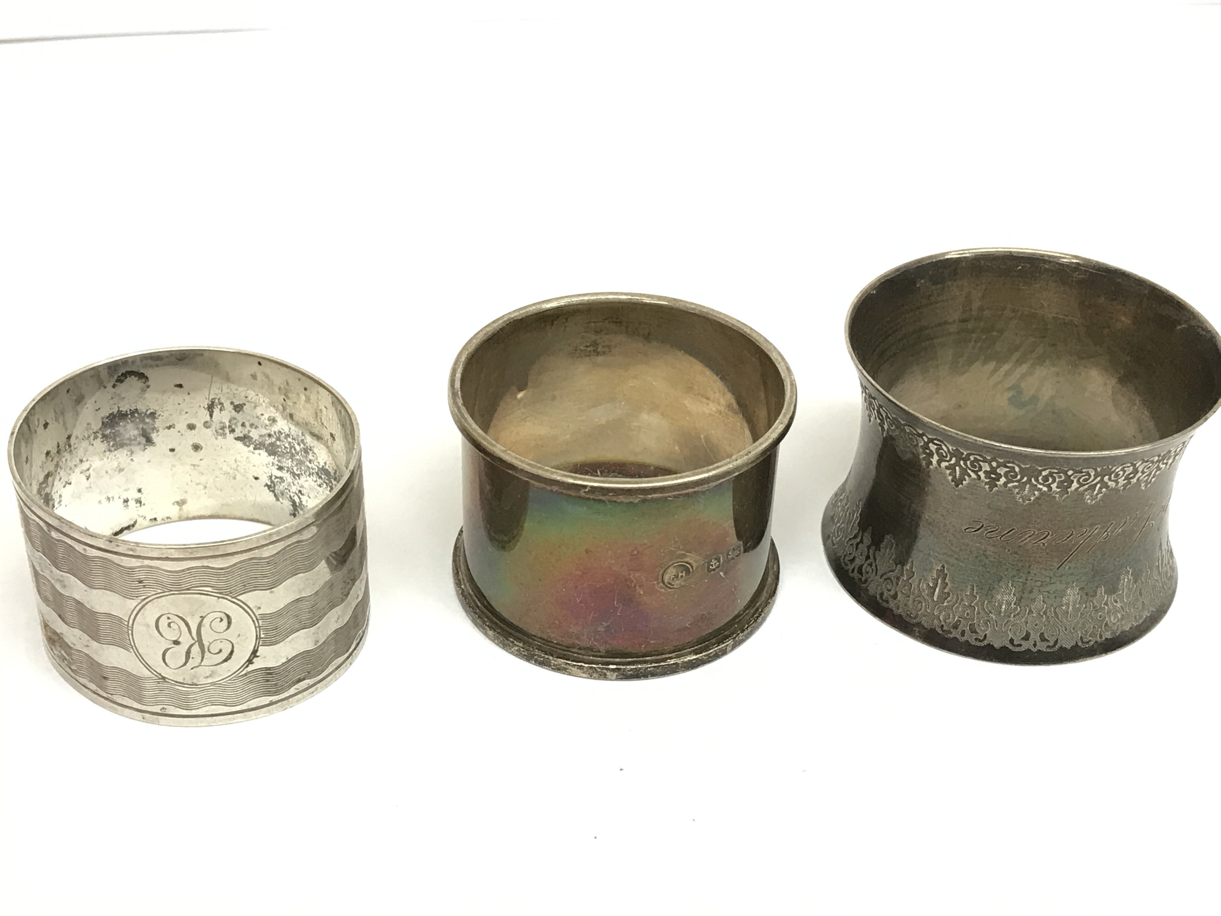 Silver hallmarked napkin rings, one not marked. Postage category A