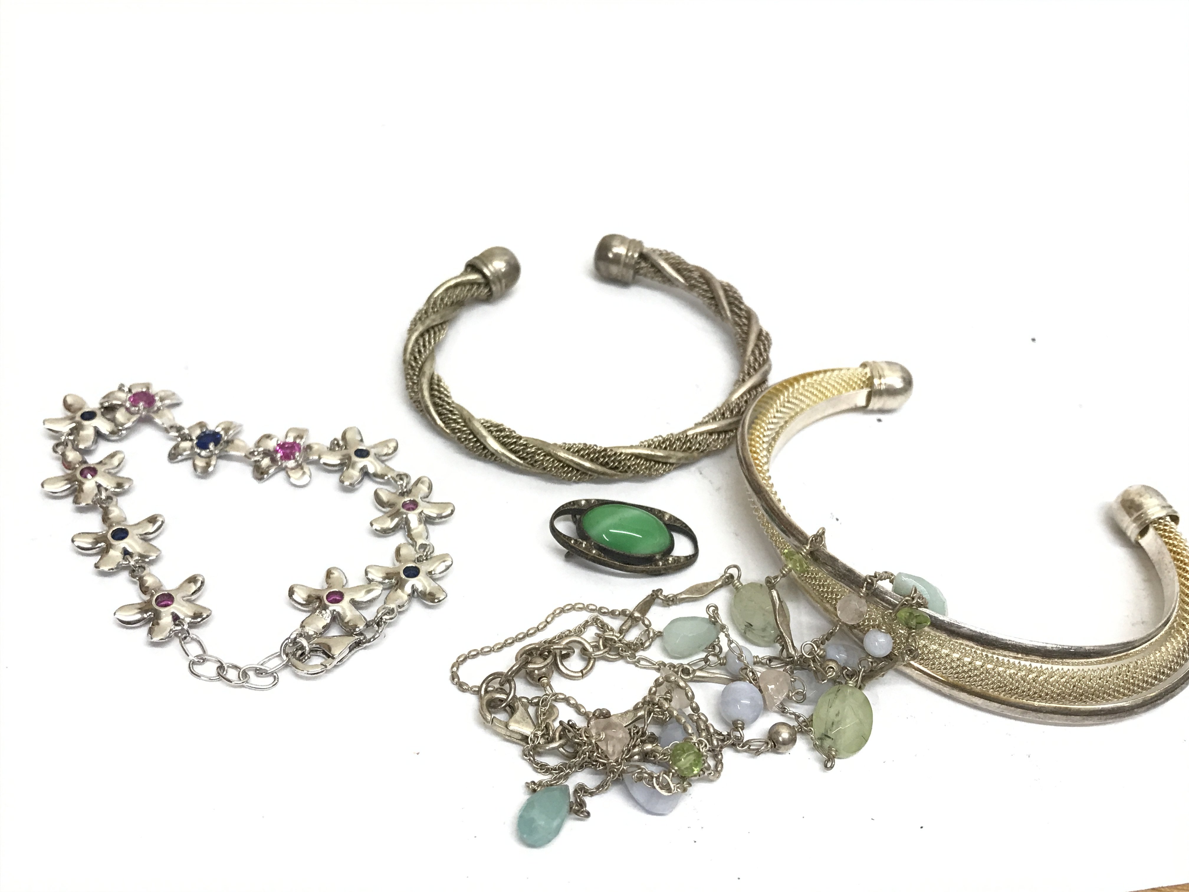 Four silver bangles . Postage category A