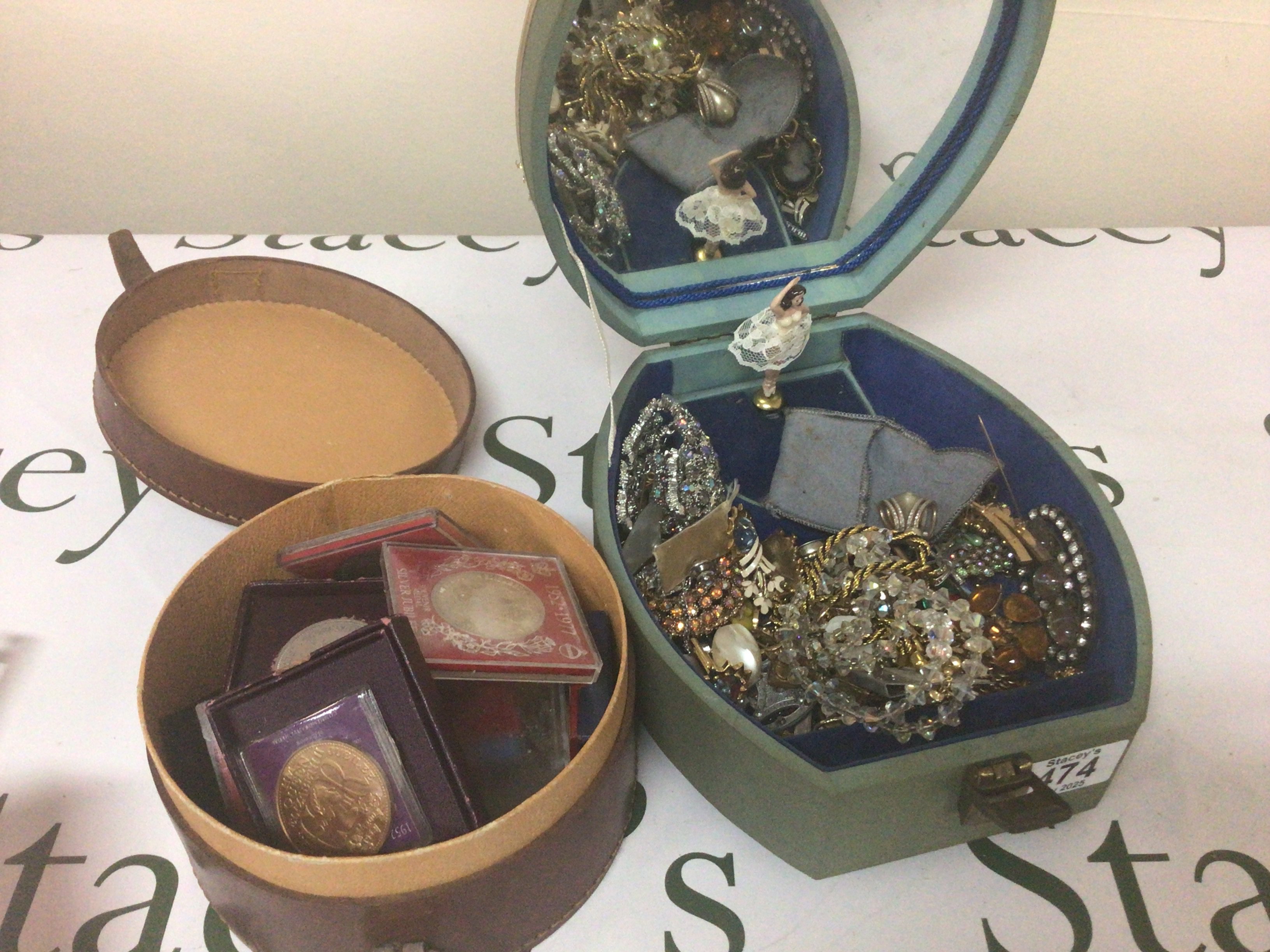 A leather collar box containing coins and a jewellery box containing costume jewellery (2)