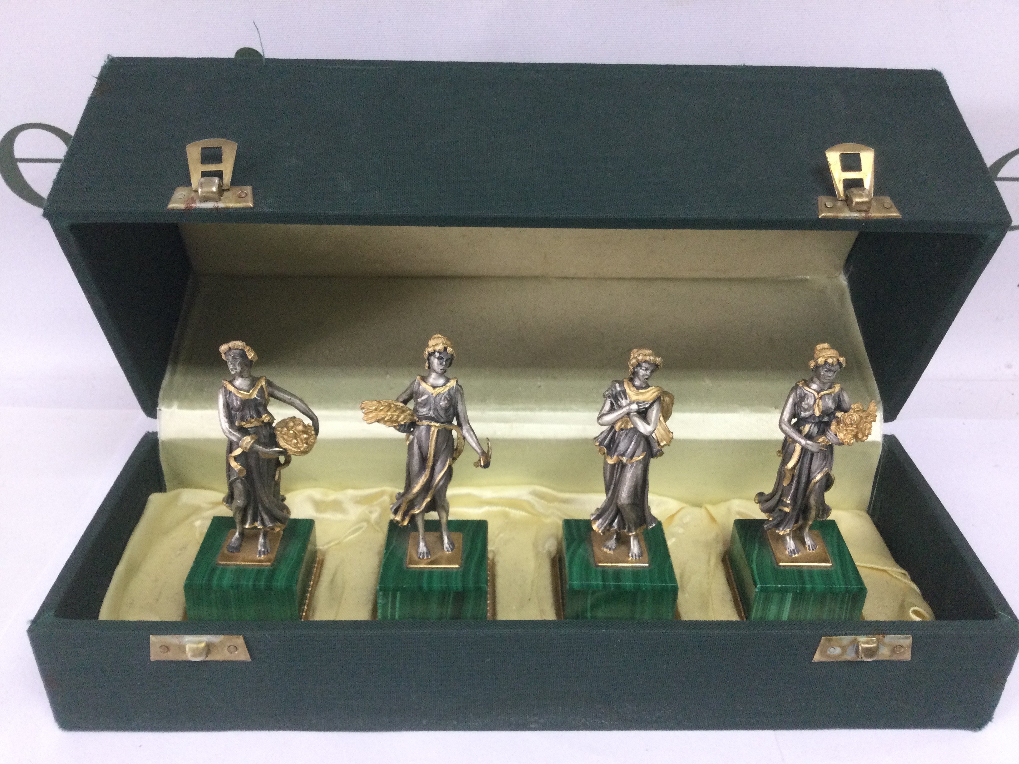 A cased set of four silver gilt figures depicting the four seasons, marked 800. Approx height 8.5cm. Shipping category B.