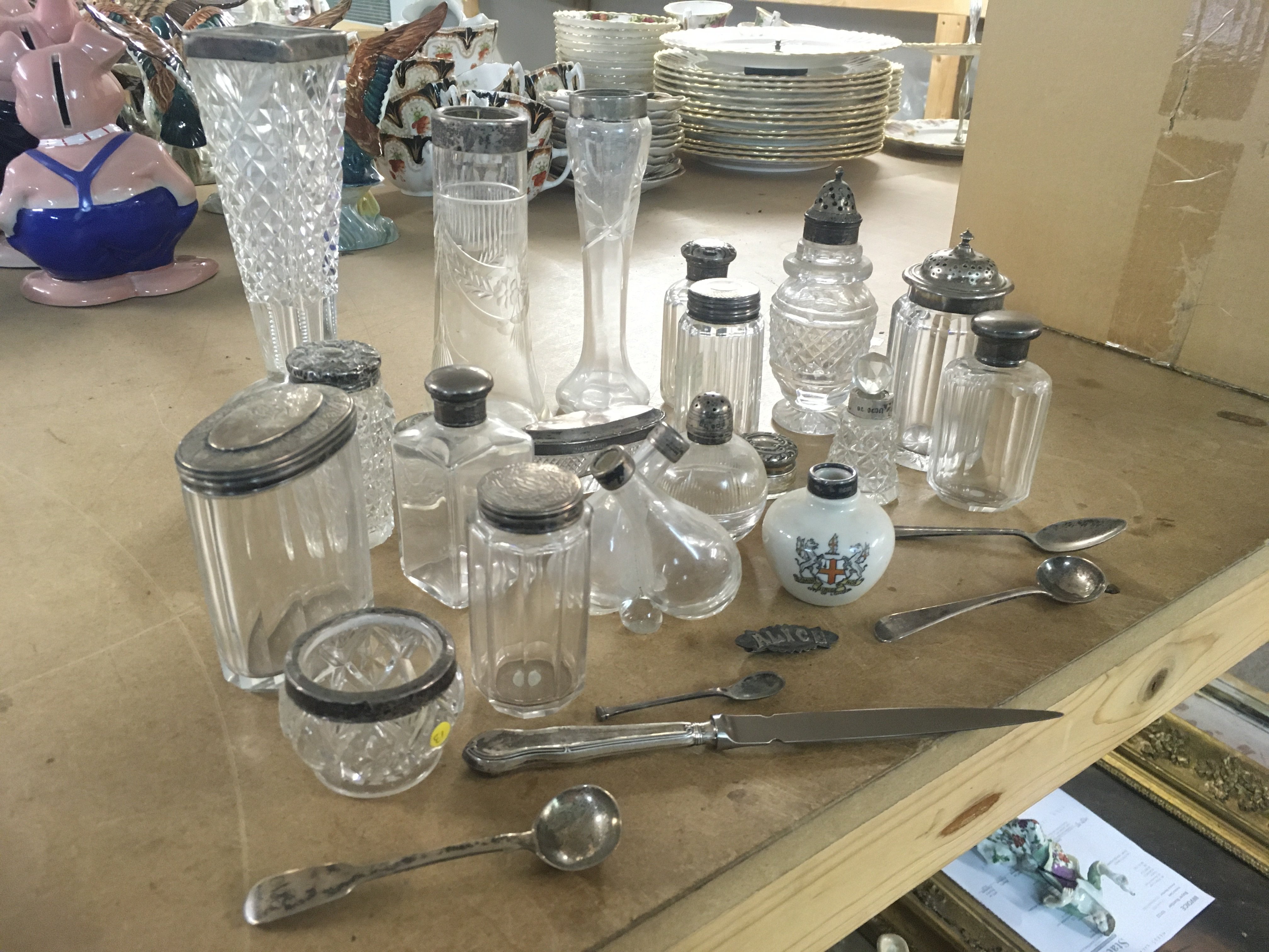 A collection of cut glass vases and containers with silver colllars and lids. Silver spoons and paper knife. This lot cannot be posted