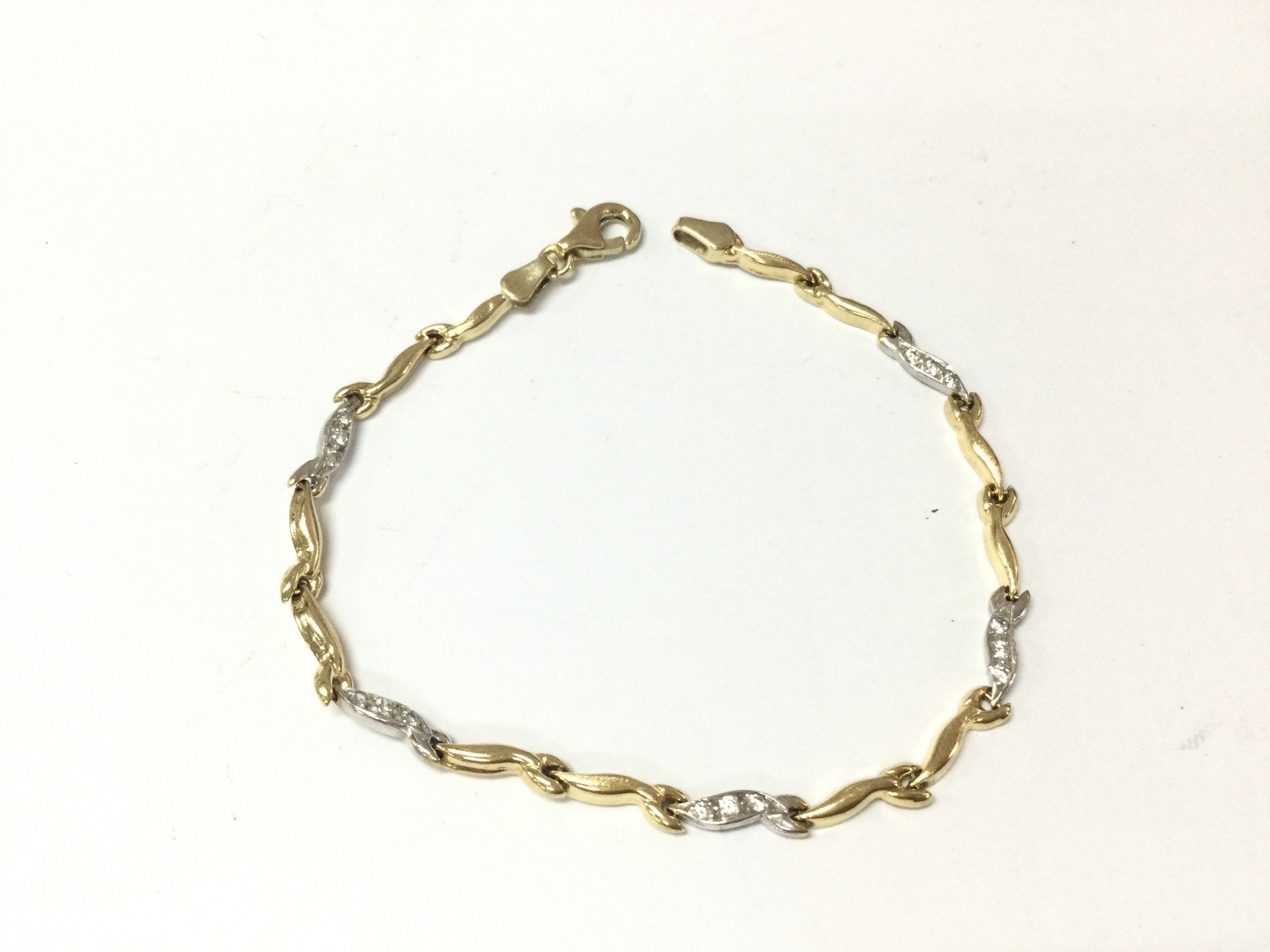 A 14ct gold bracelet. Yellow and white gold with white stones. 4.47g