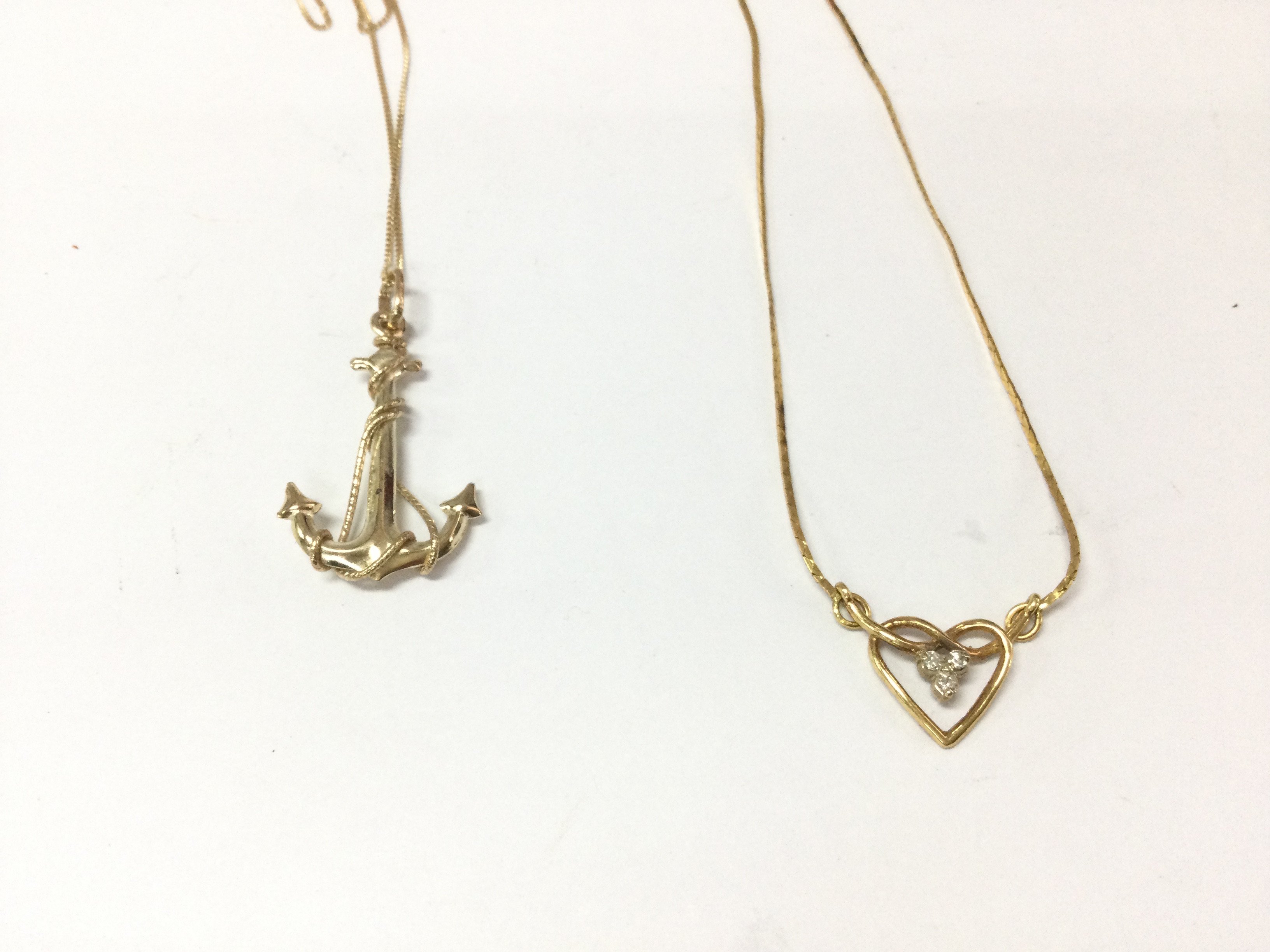 A 9ct gold chain with anchor pendant and a 9ct gold necklace. 3.93g total. Postage A