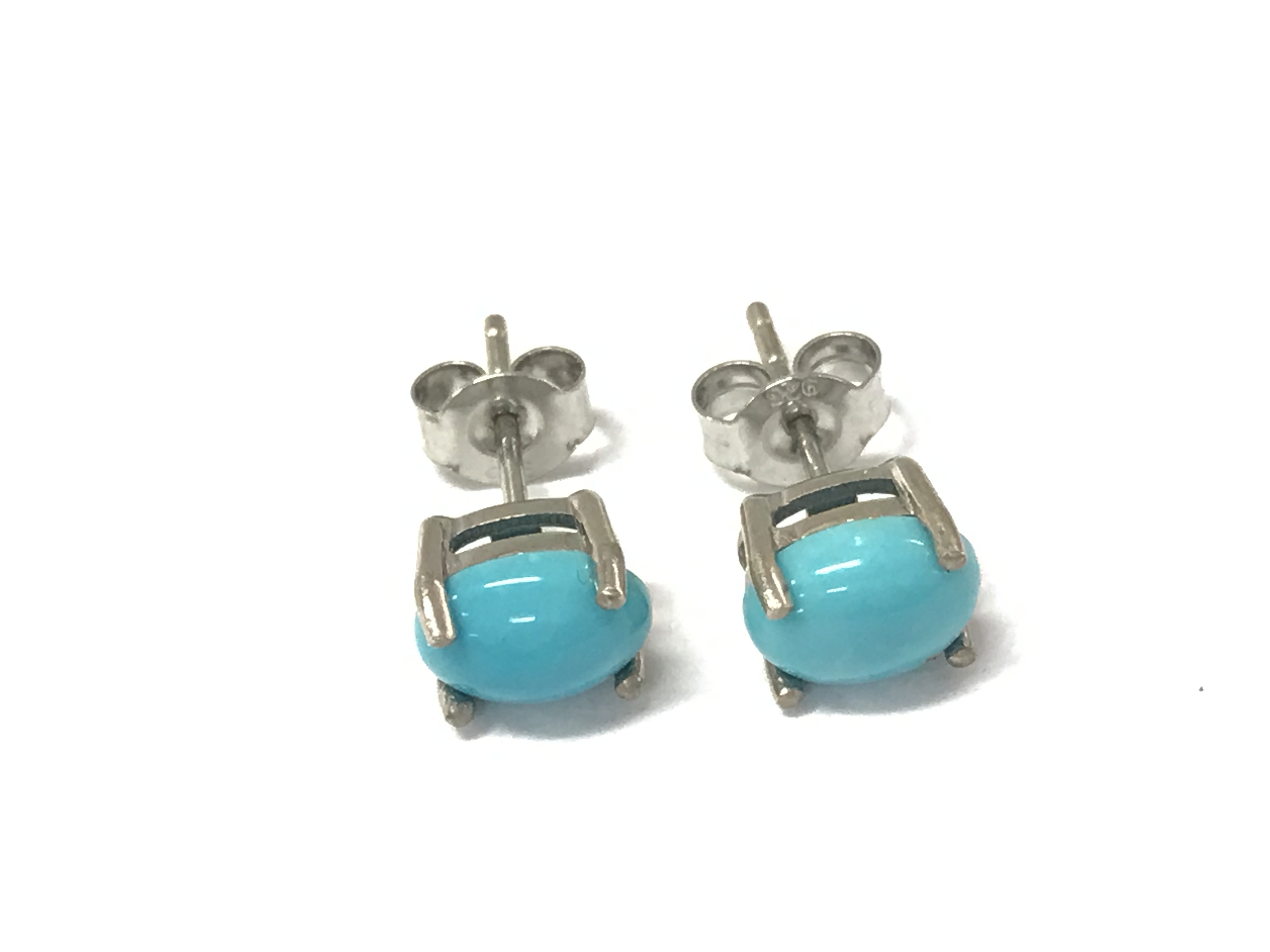 A pair of oval cabochon turquoise studs in silver. Postage A