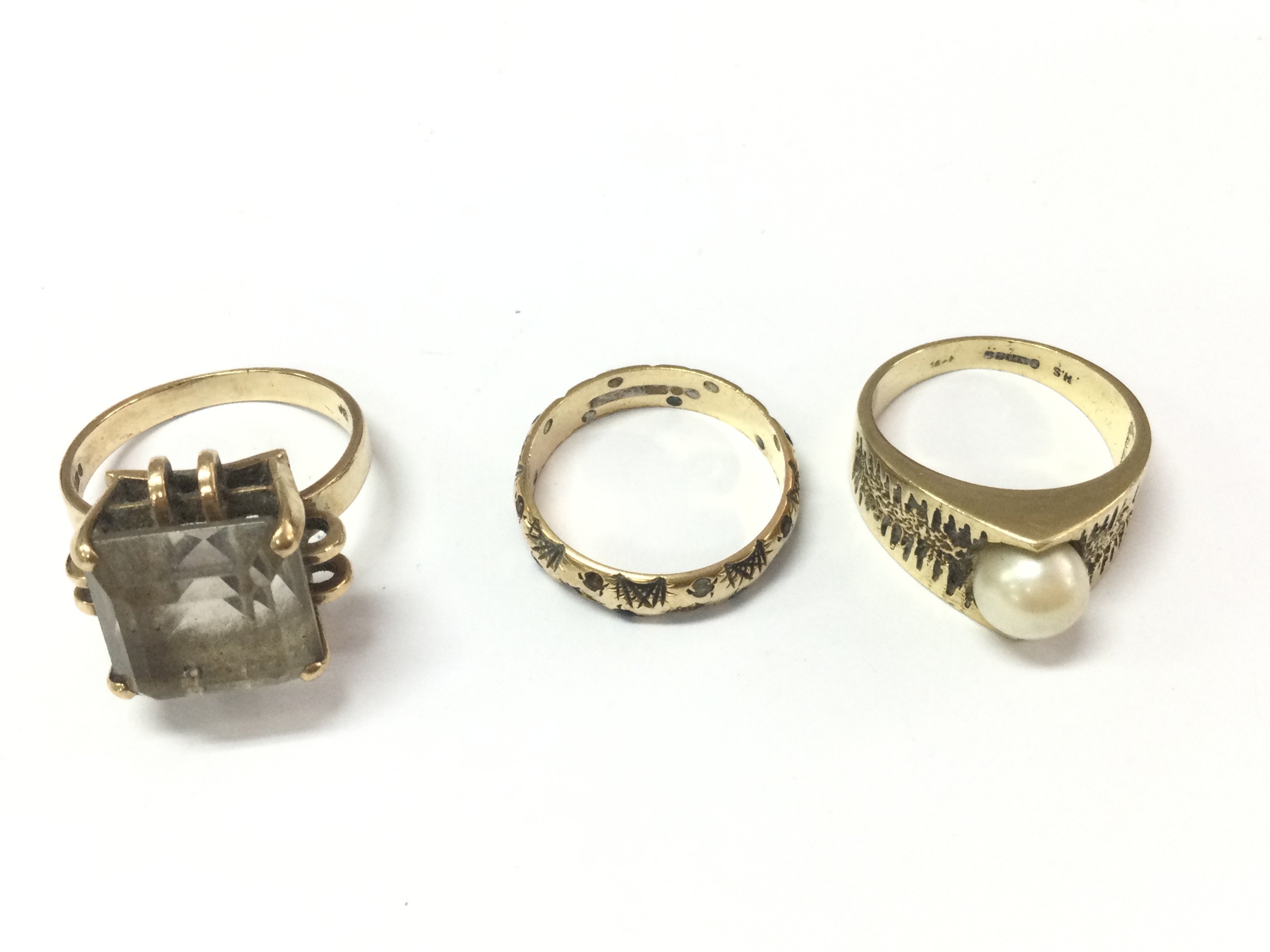 A collection of three 9ct gold rings. 12.08g Postage B