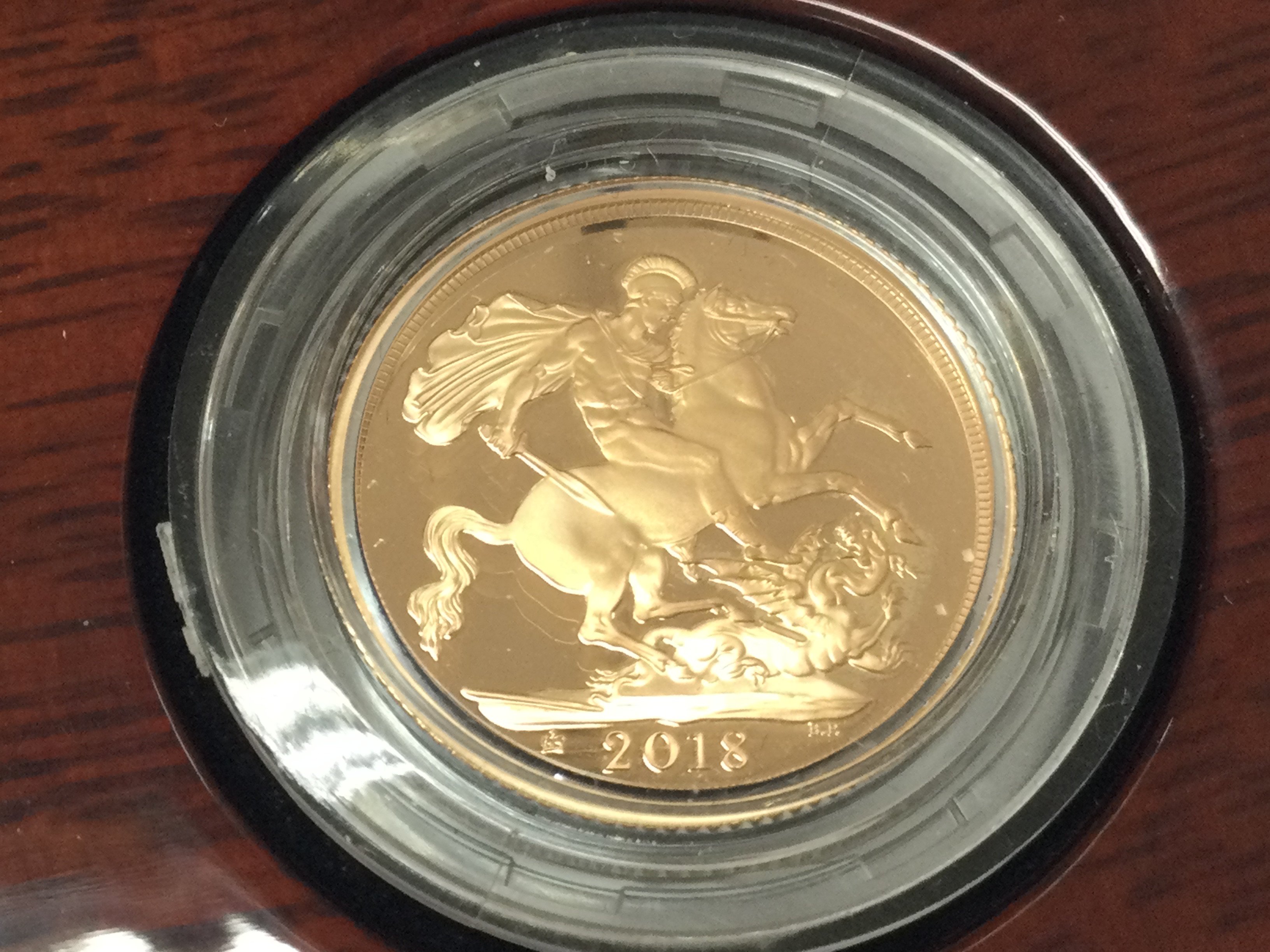 A 2018 gold proof sovereign with box and COA.