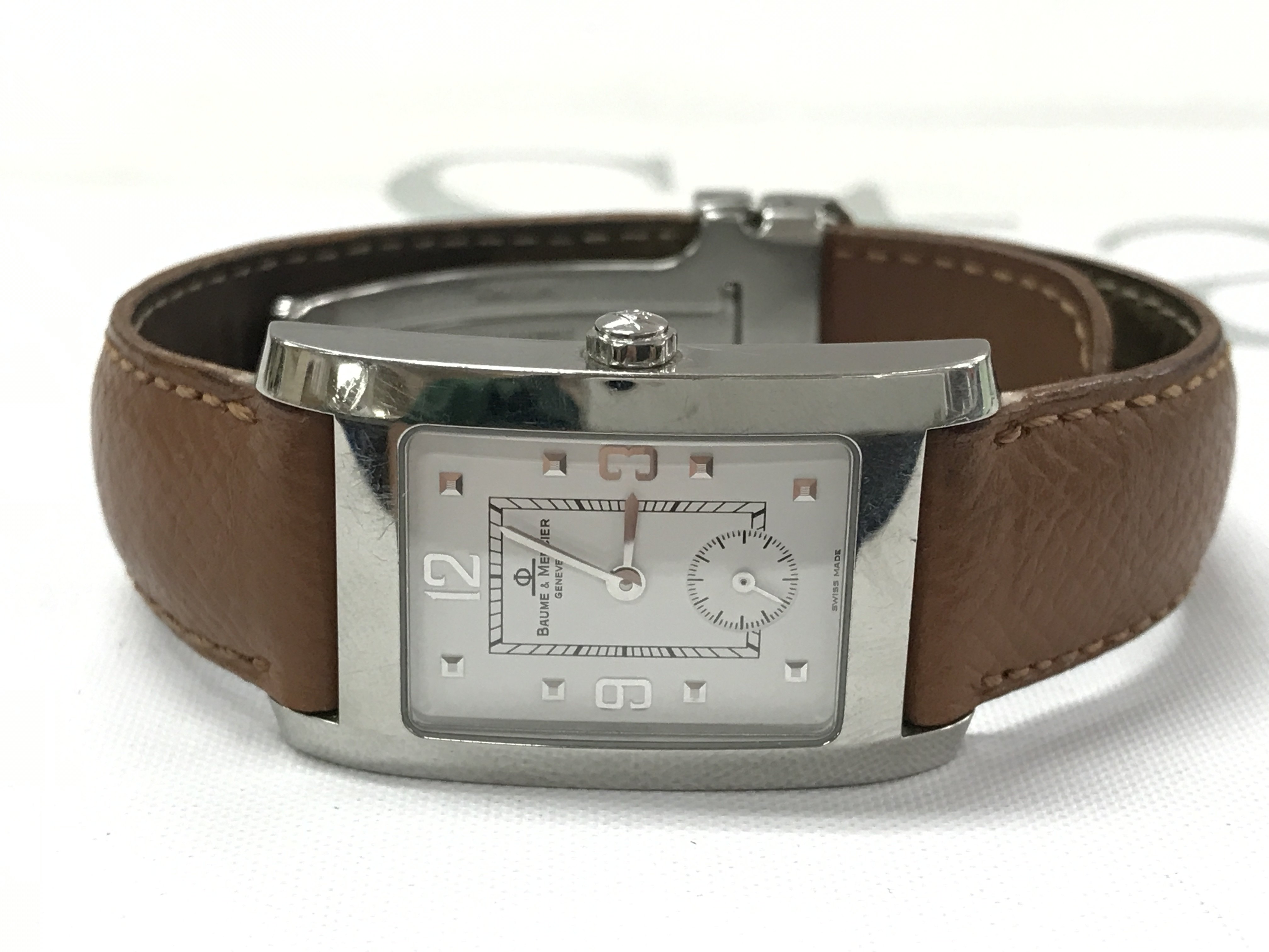 A Baume & Mercier watch in a brown leather strap . Postage category A