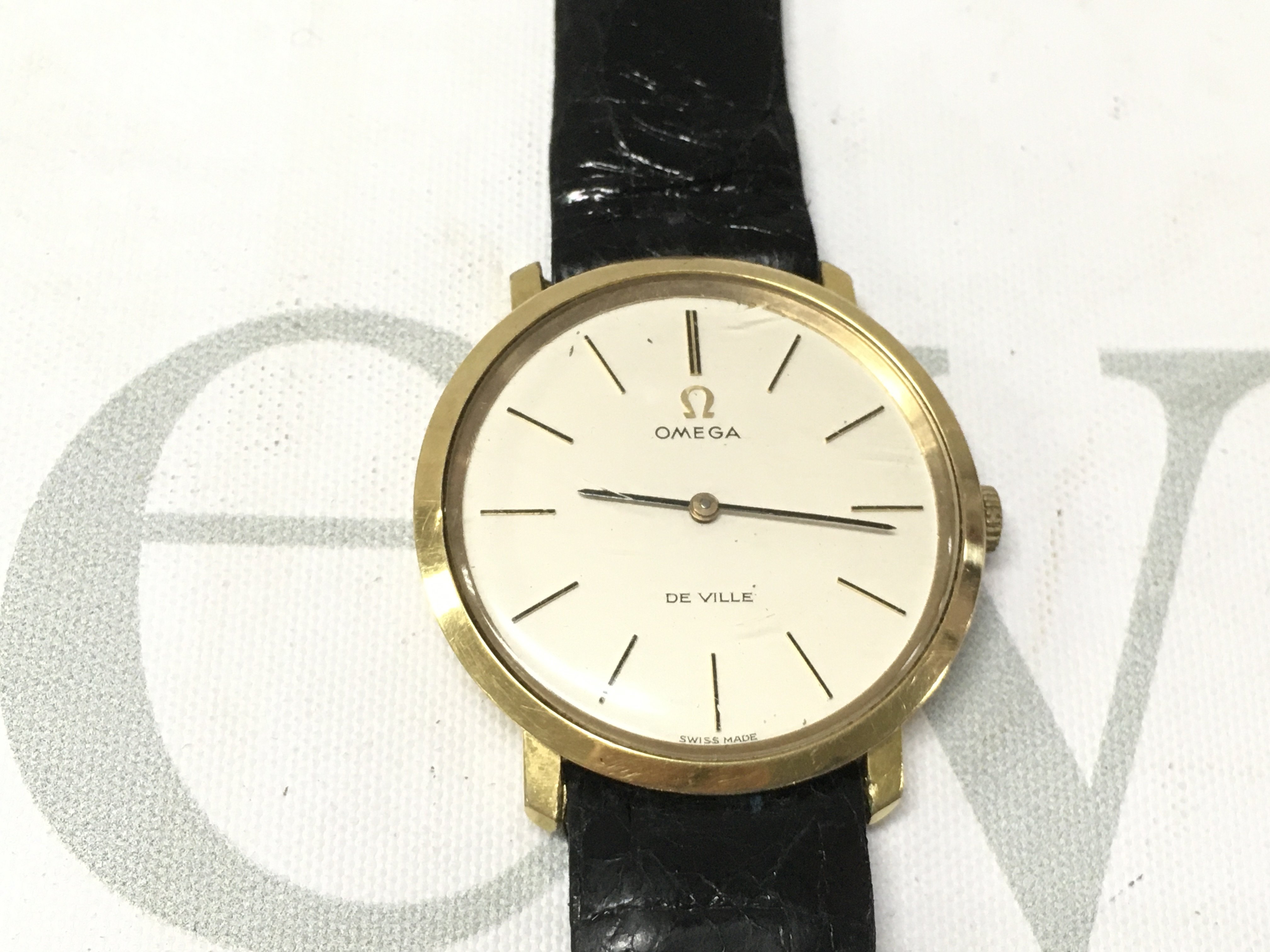 A gent omega de ville watch seen working on a black leather strap. Postage B