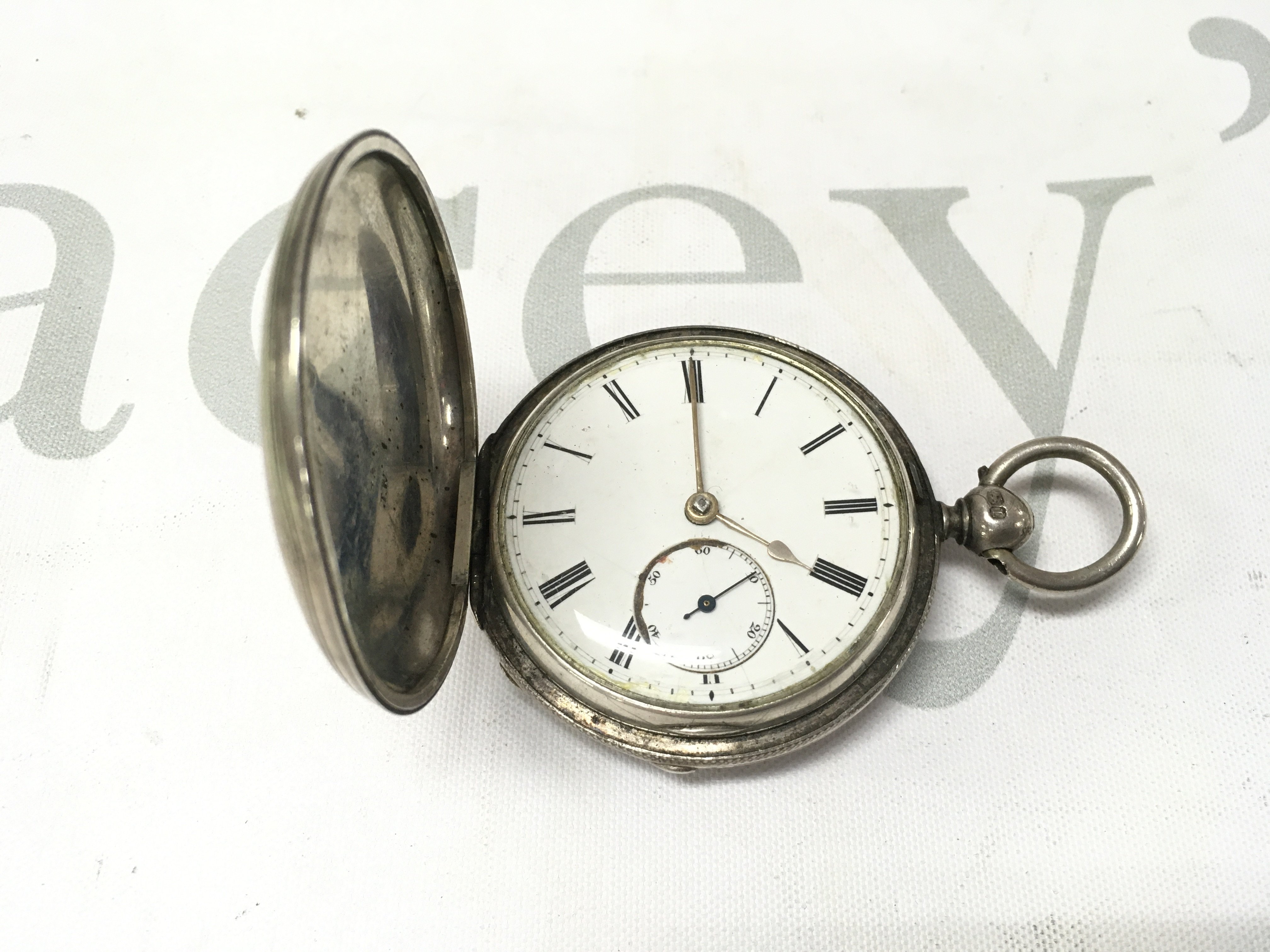 A silver full hunter pocket watch. Not seen running.