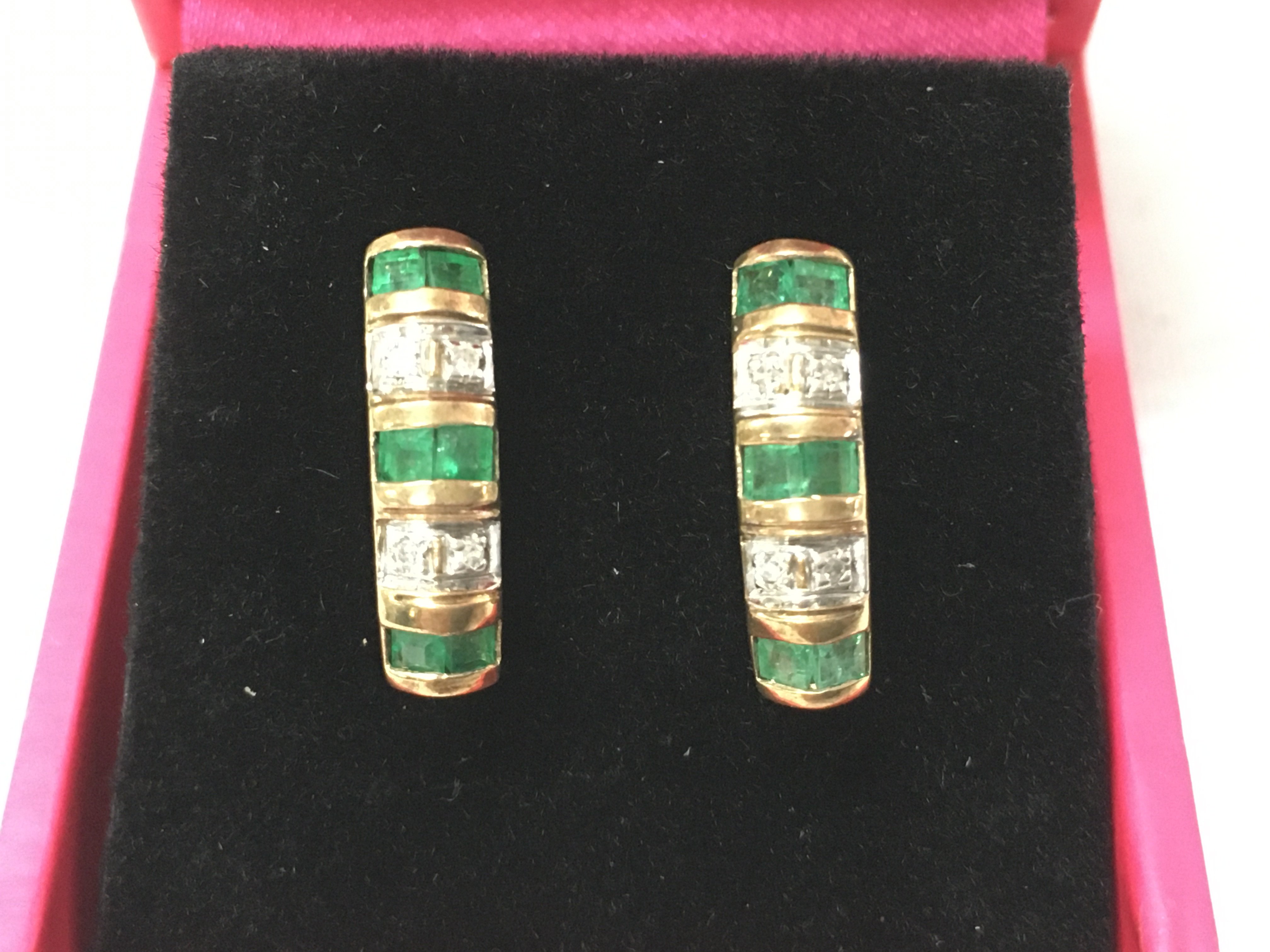 A pair of 9ct gold earring set with emeralds and diamonds. Postage B
