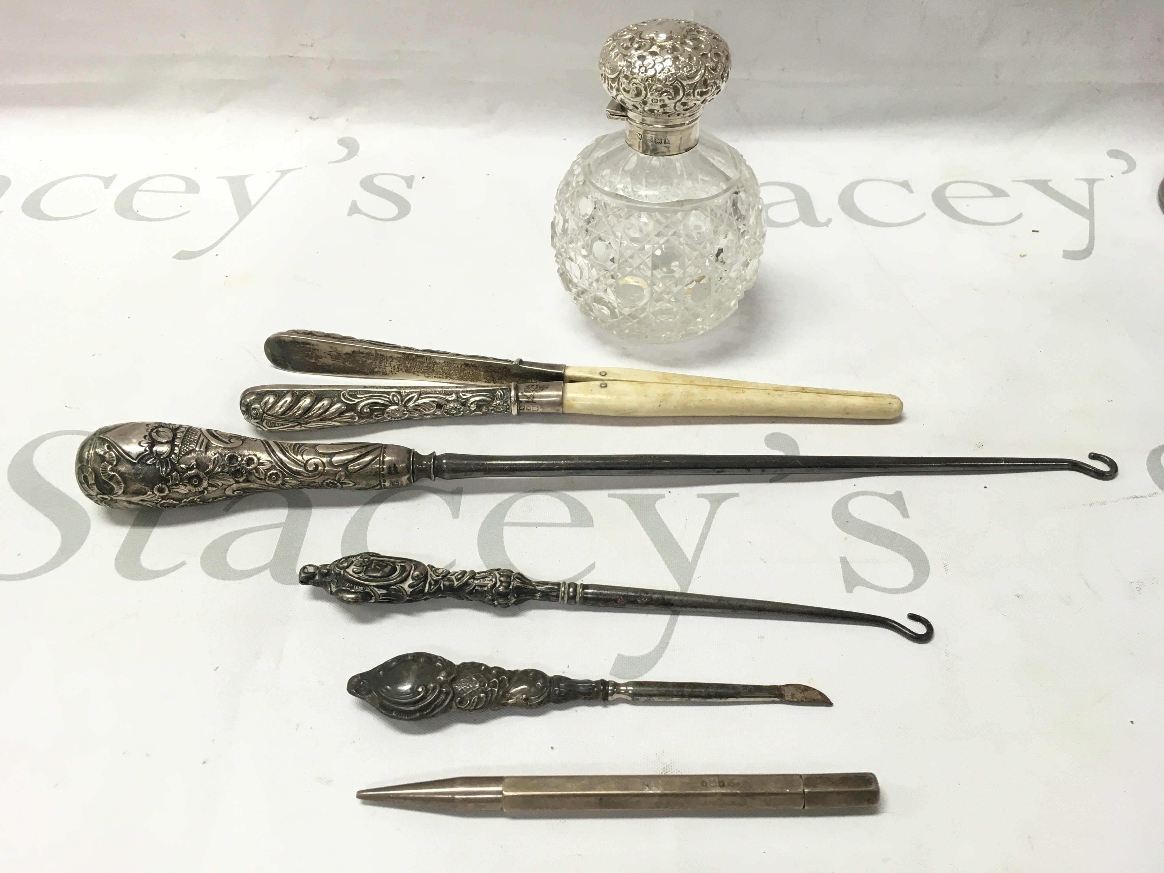 A collection of silver items to include scent bottles pencils etc.