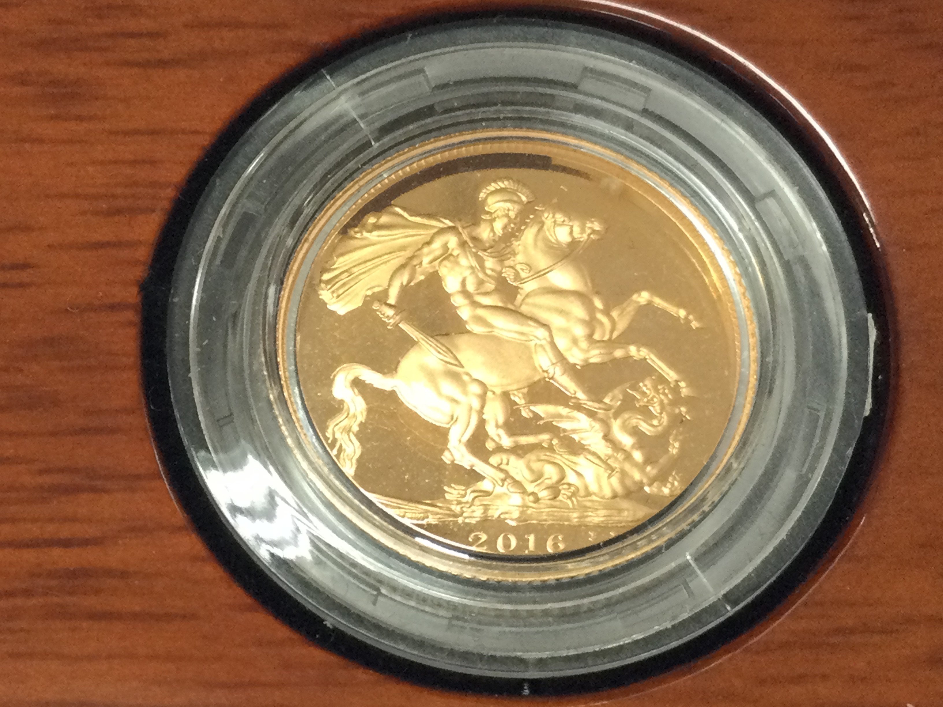 A 2016 gold proof sovereign with box and COA.Postage B