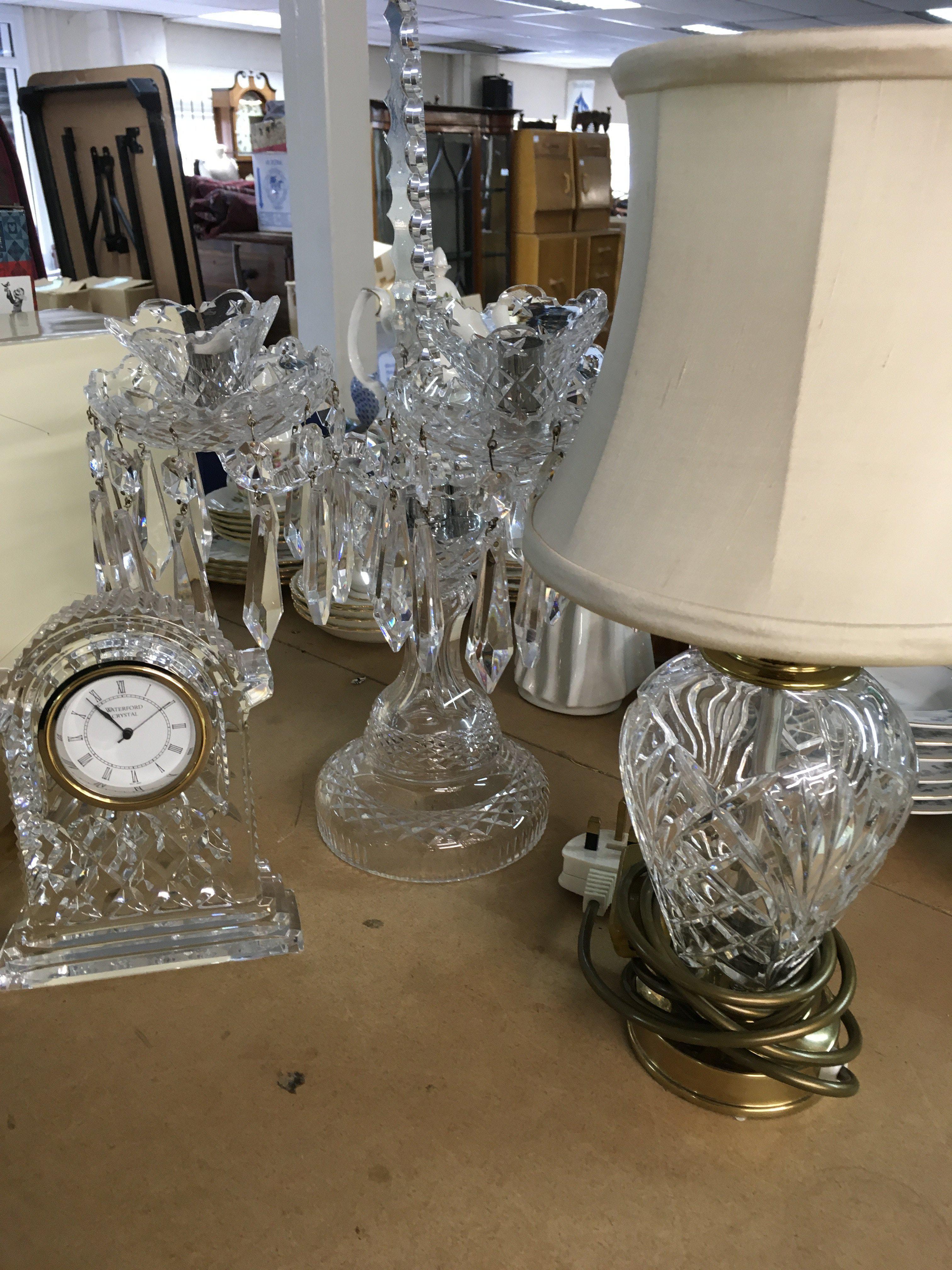 A Waterford Crystal clock together with a Baccarat style candelabra and a cut glass table lamp .