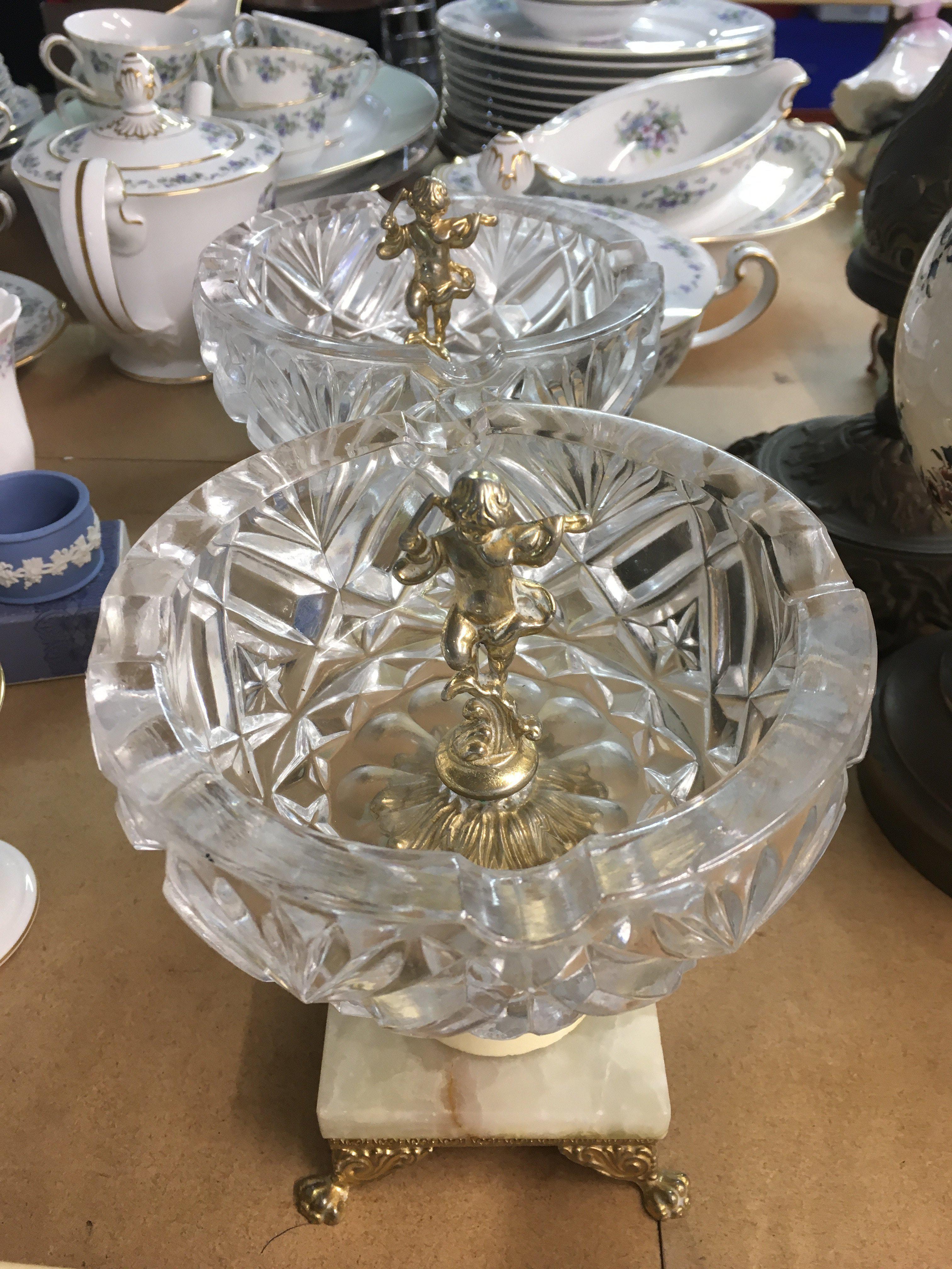 A pair of glass bowls inset with cherubs .on onx bases .