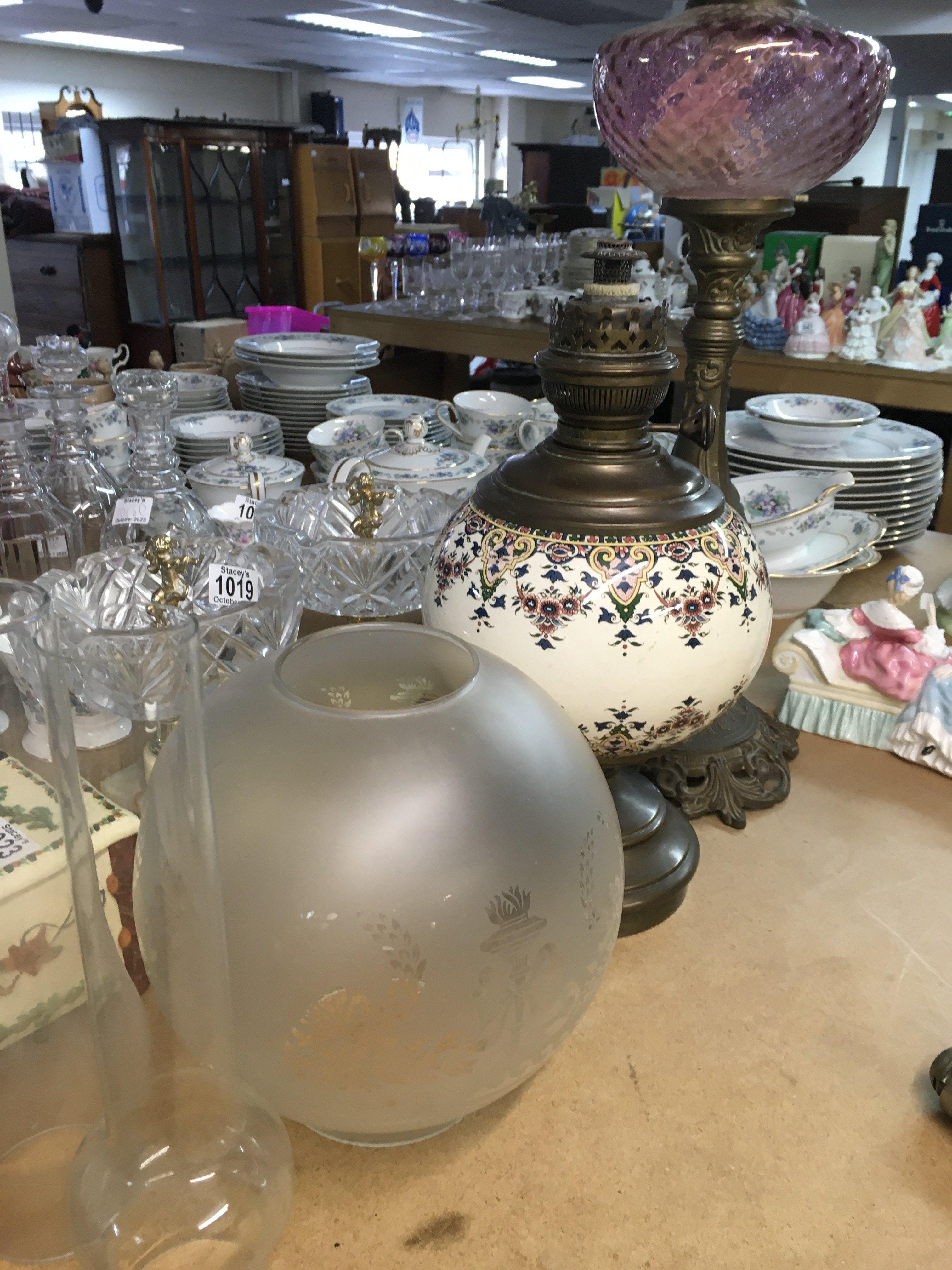 Two victorian style oil lamps .