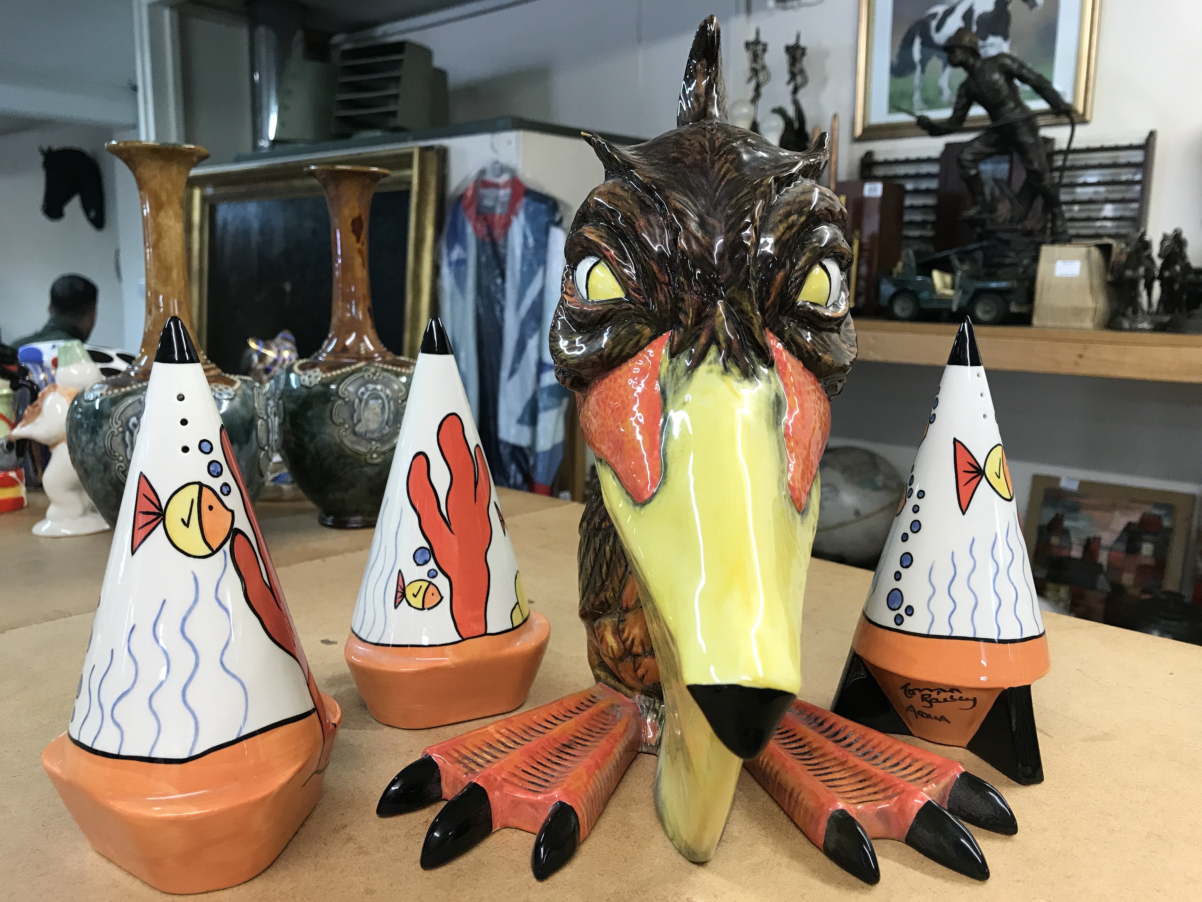 A large Lorna Bailey figurine of a Pelican. Height 28cm, limited edition 33/50- signed on the base. Together with three Lorna Bailey "Aqua " pattern sugar shakers.