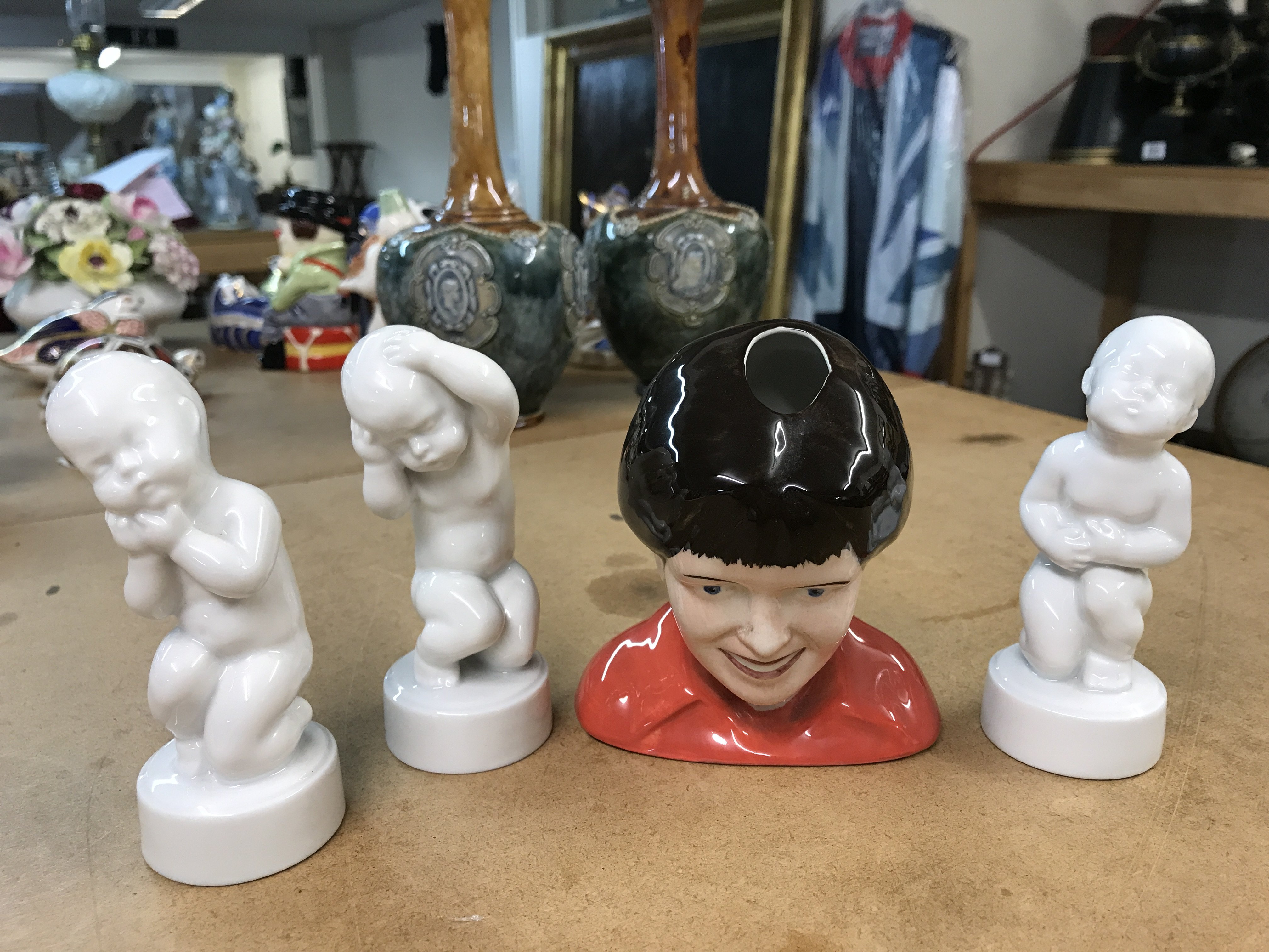A Lorna Bailey limited edition "head" vase 59/100, together with three White Cherub figurines