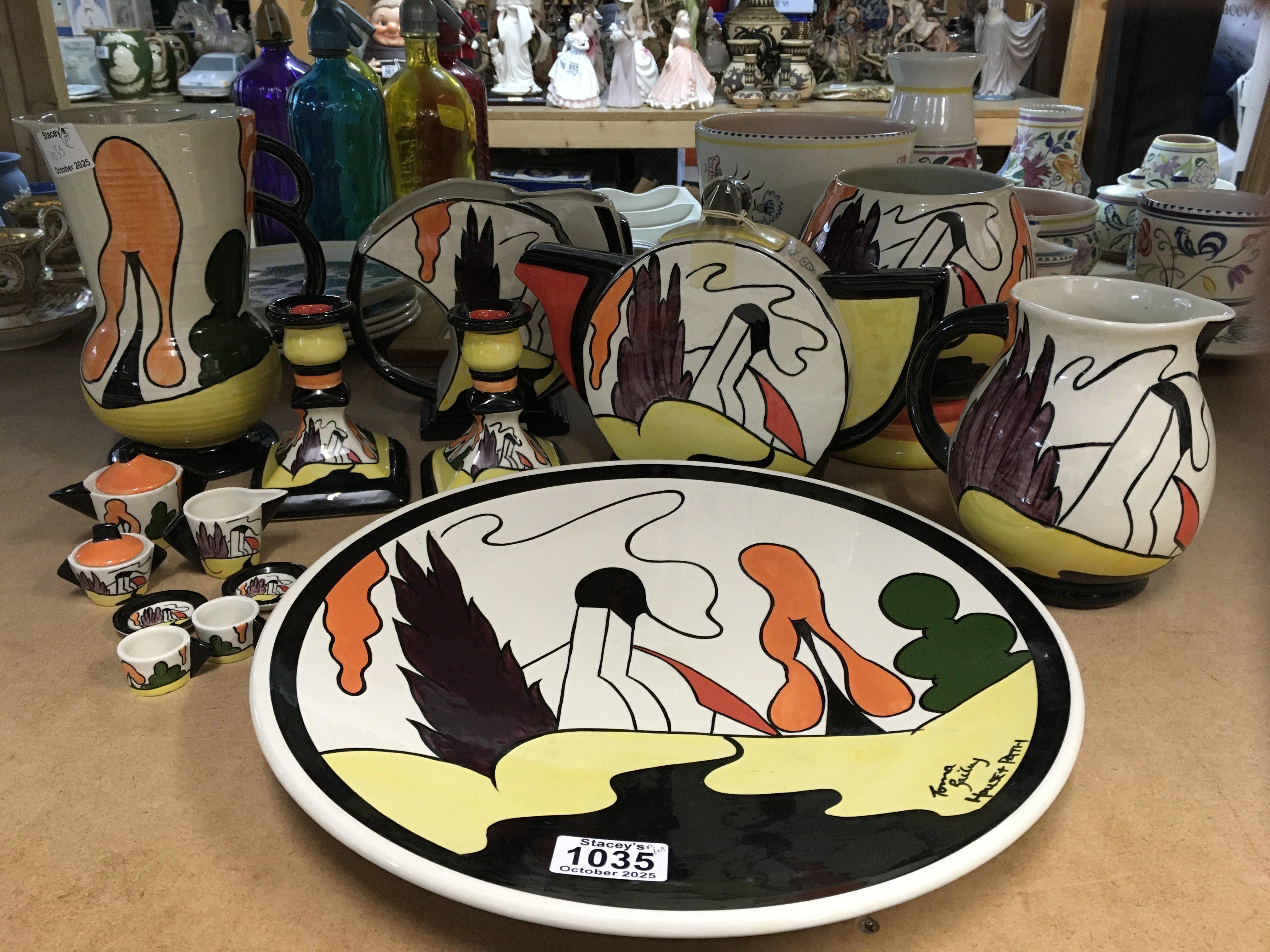 A collection of Lorna Bailey pottery in the "House and Path" range, to include charger, tea pot, two vases, two jugs, pair of candlesticks and a miniature tea set