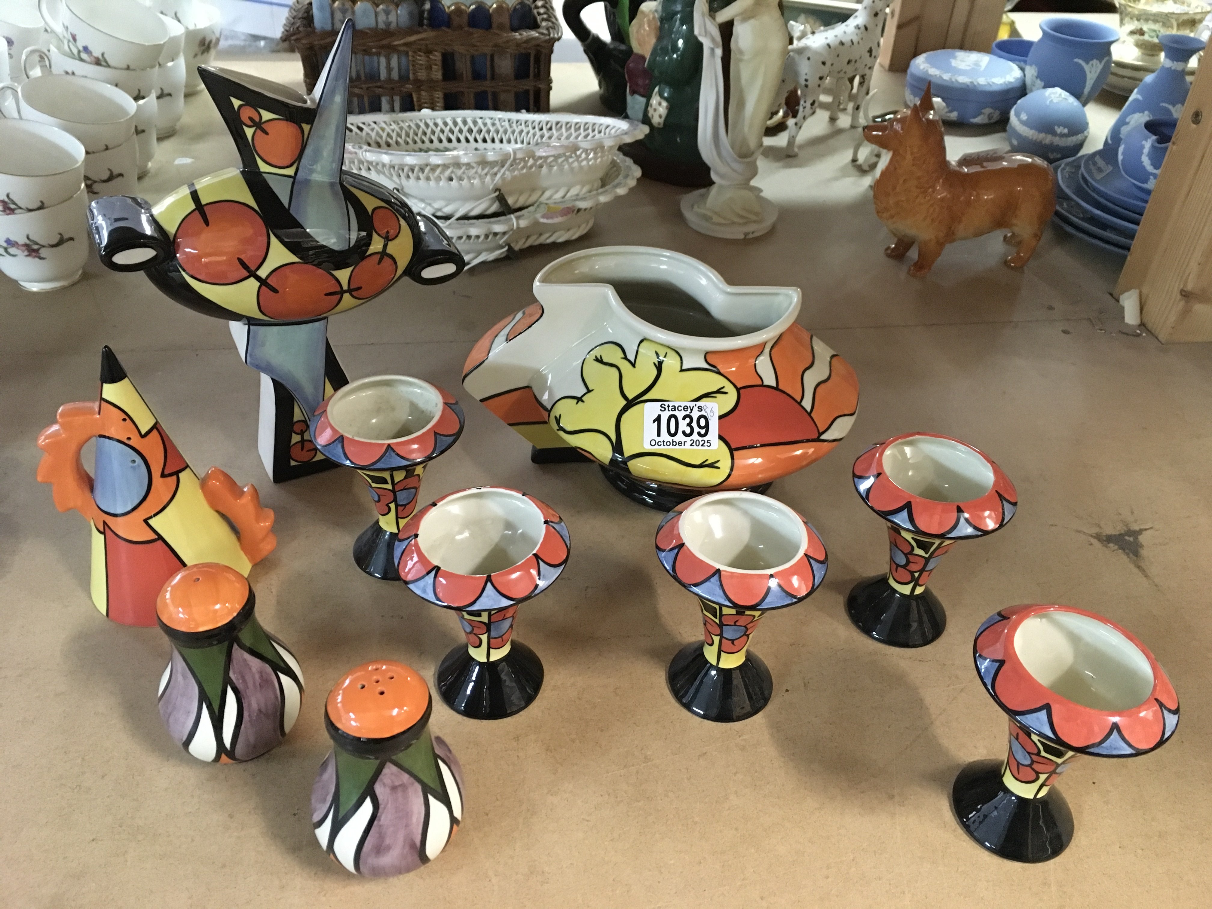 A collection of Lorna Bailey items including "Oaklands" geometric shaped vase, bud vases, salt and pepper pot, decorative vase and 3rd limited edition Sunset sugar shaker