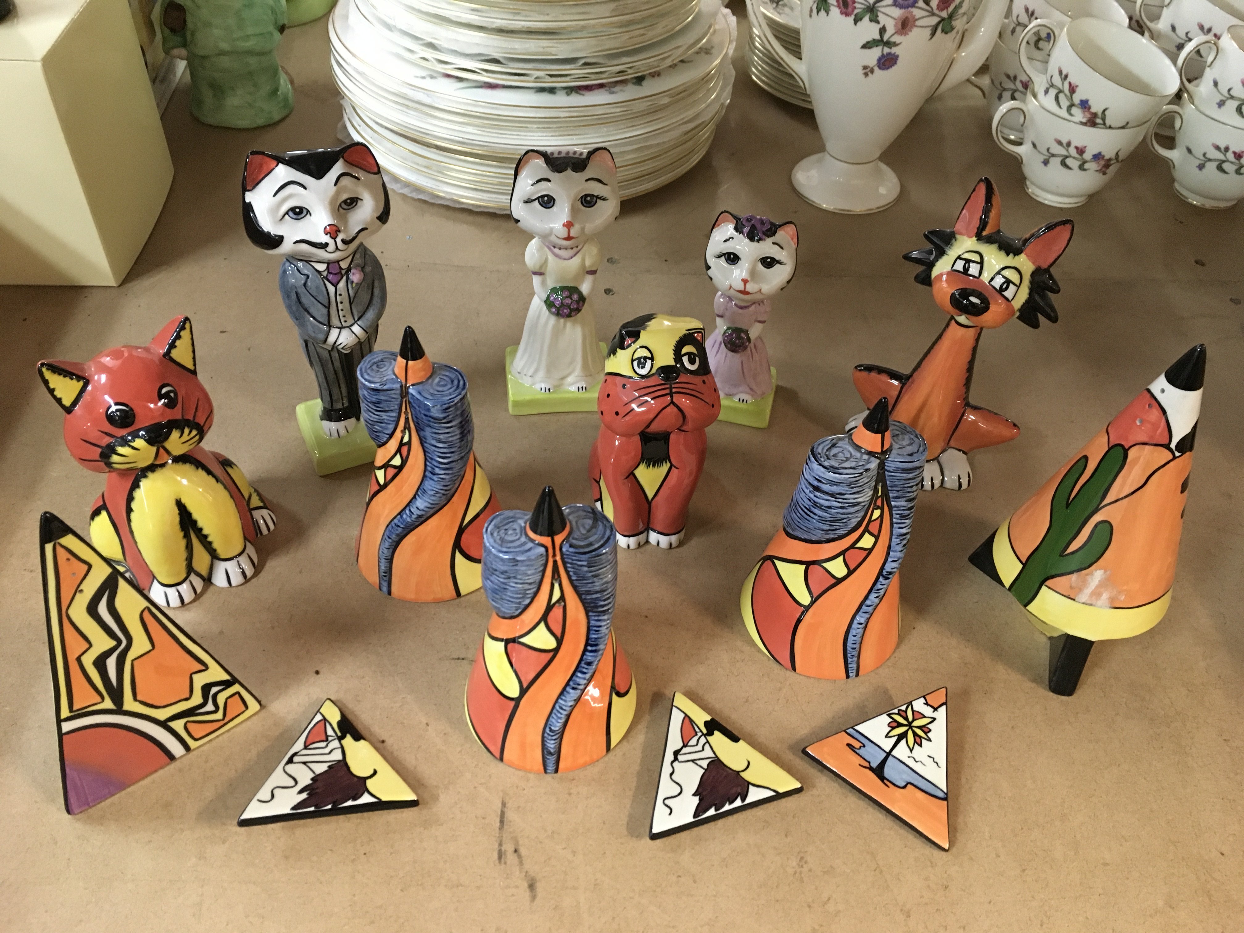 A collection of various Lorna Bailey pottery, including Cat Bride and Groom, other animals, triangle brooches and Sugar Shakers
