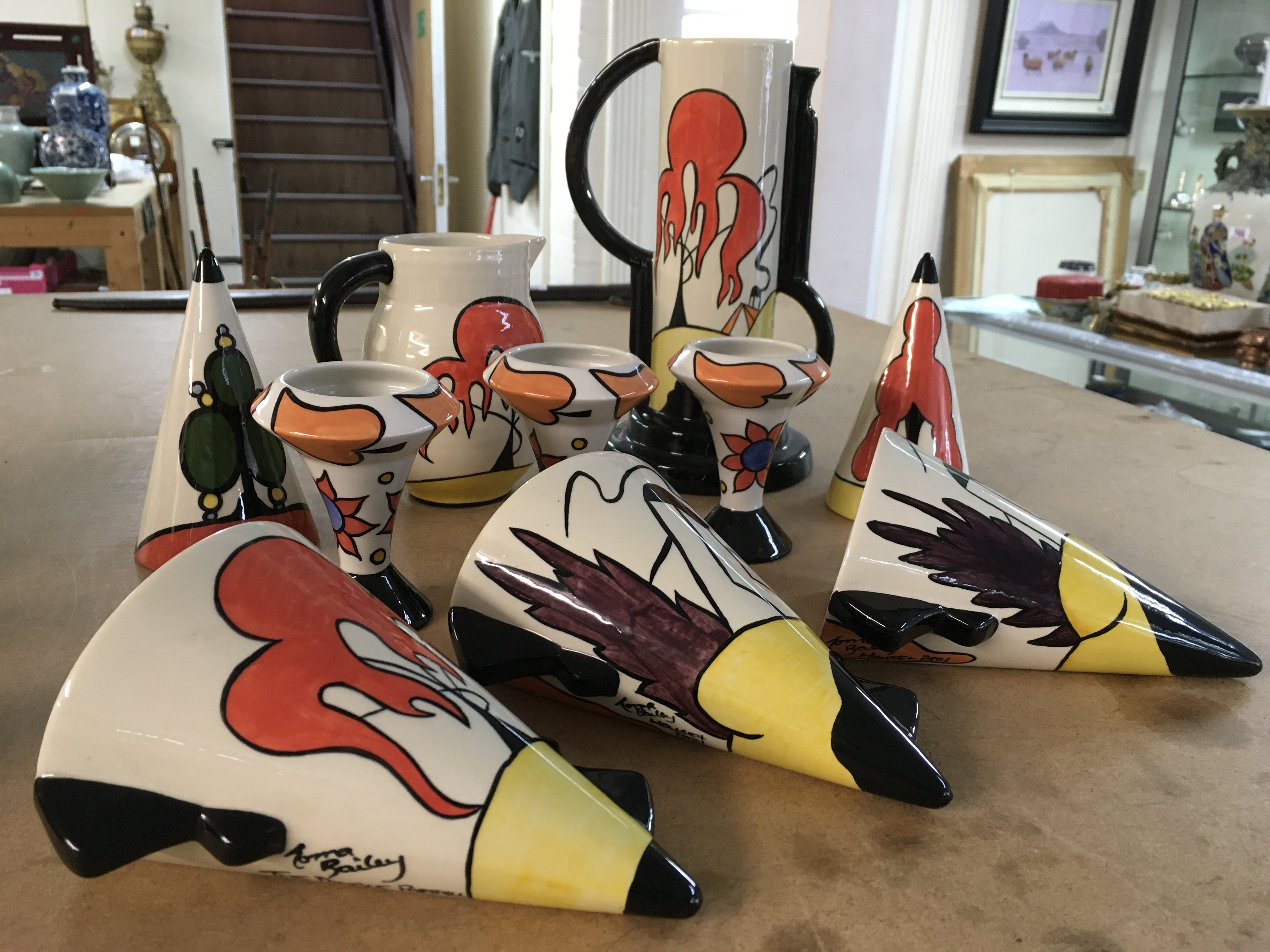 Lorna Bailey items, including wall pockets, vase, jug, miniature vases and two sugar shakers. (Patterns include "House and Path and "The Dingle Porthill")