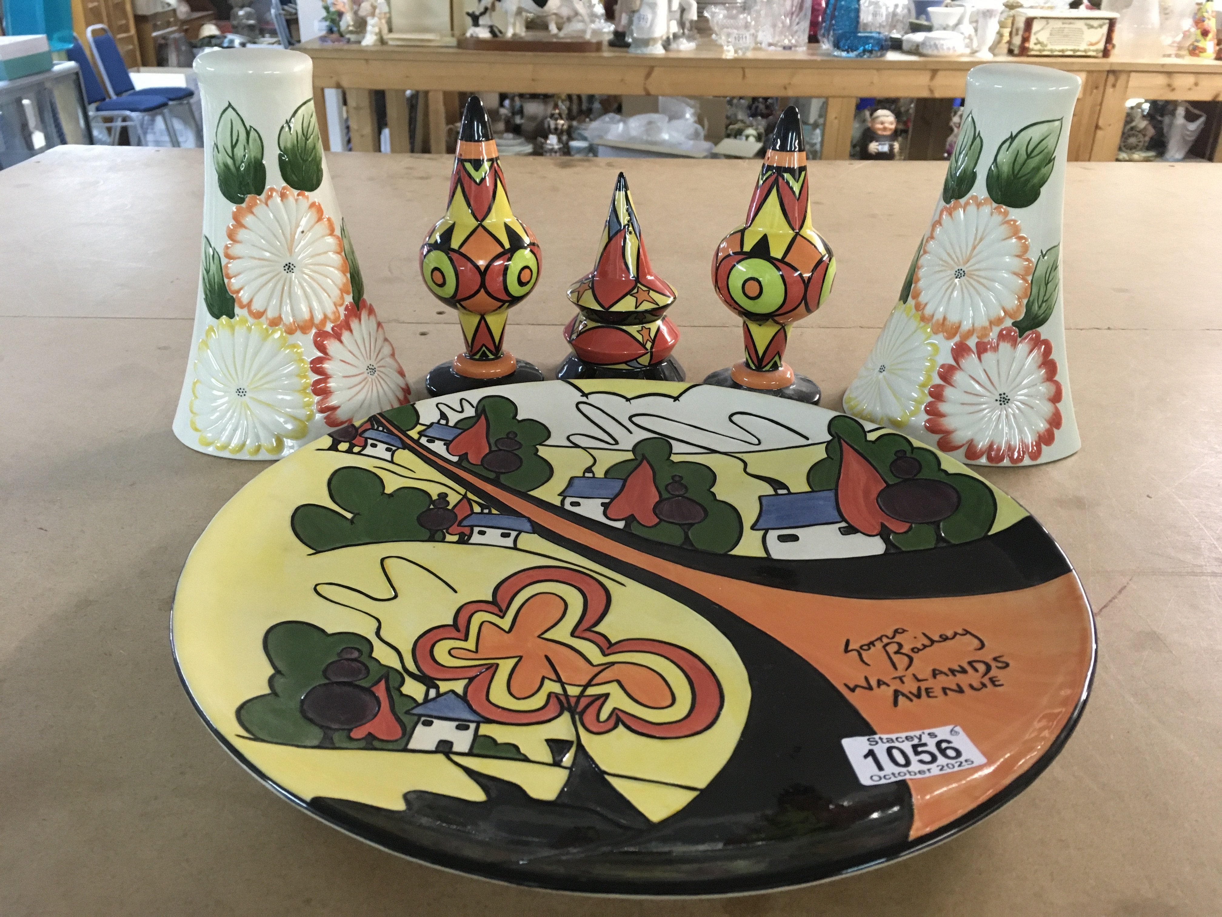 Six Lorna Bailey pottery pieces including Watlands Avenue limited edition 72/100 plaque, a pair of floral wall pockets, limited edition sugar shakers 2/50 and 3/50 and a Bewitched pattern sugar shaker