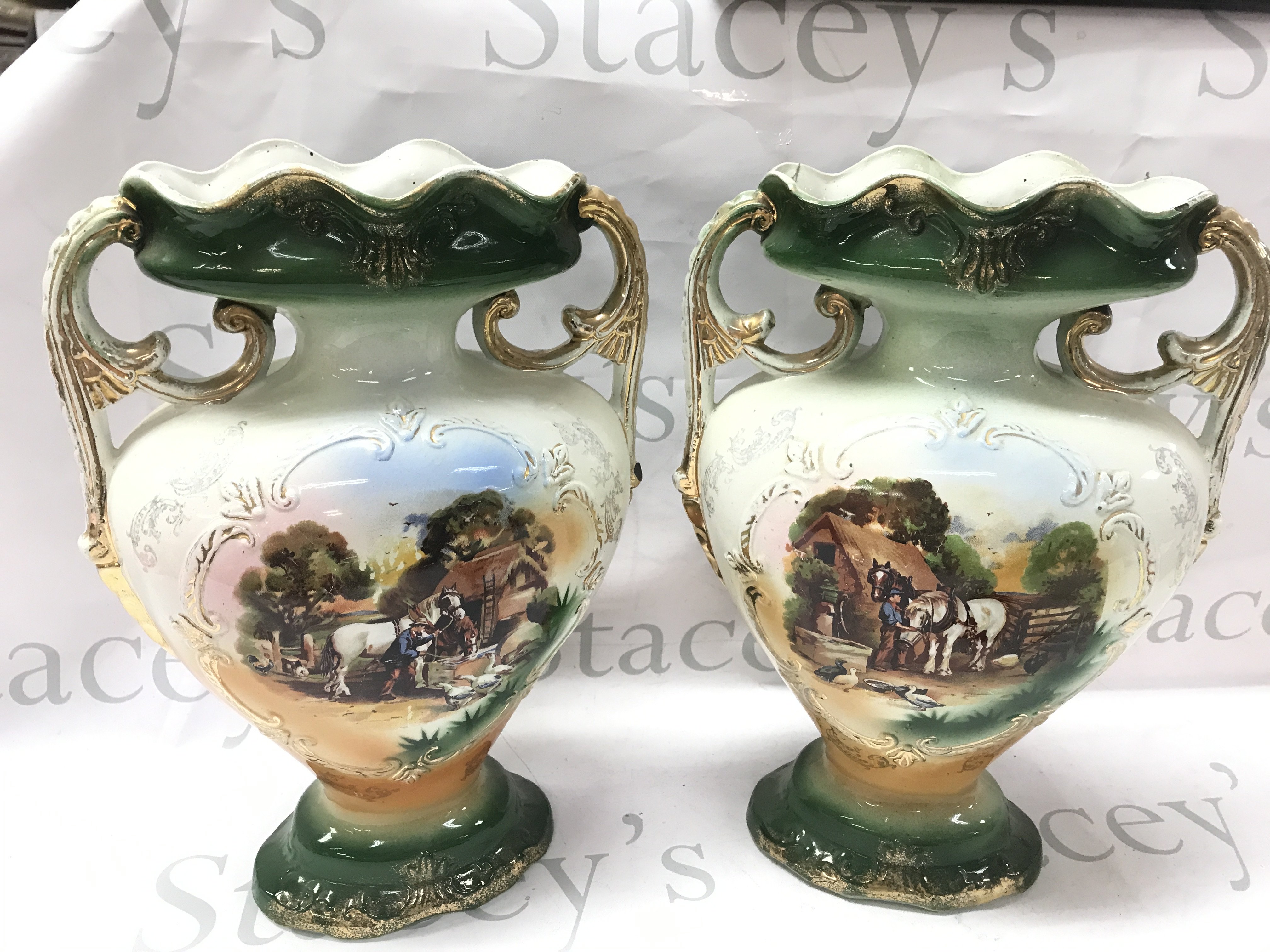 A pair of New Victor porcelain vases with countryside farm scene decorations 36cm tall . This lot cannot be posted