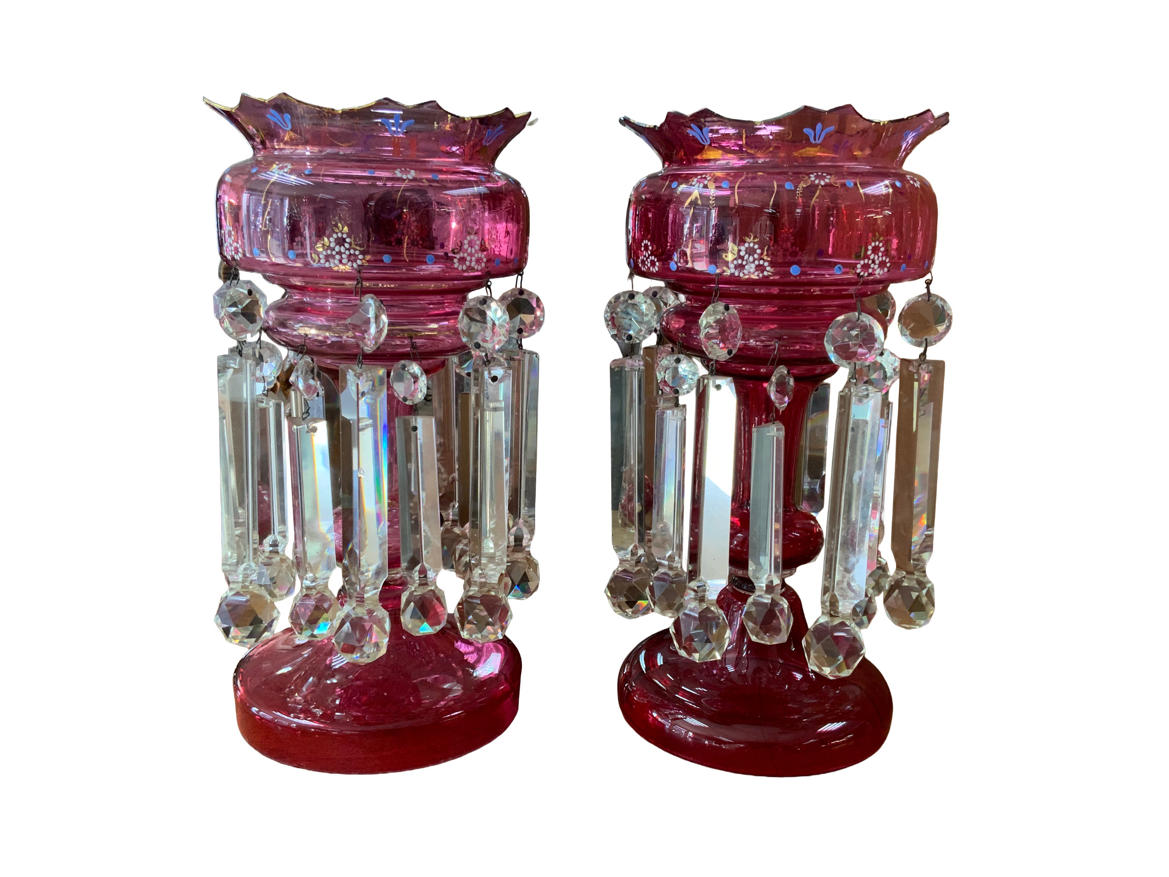A good pair of Victorian cranberry glass lustres. 36cm.