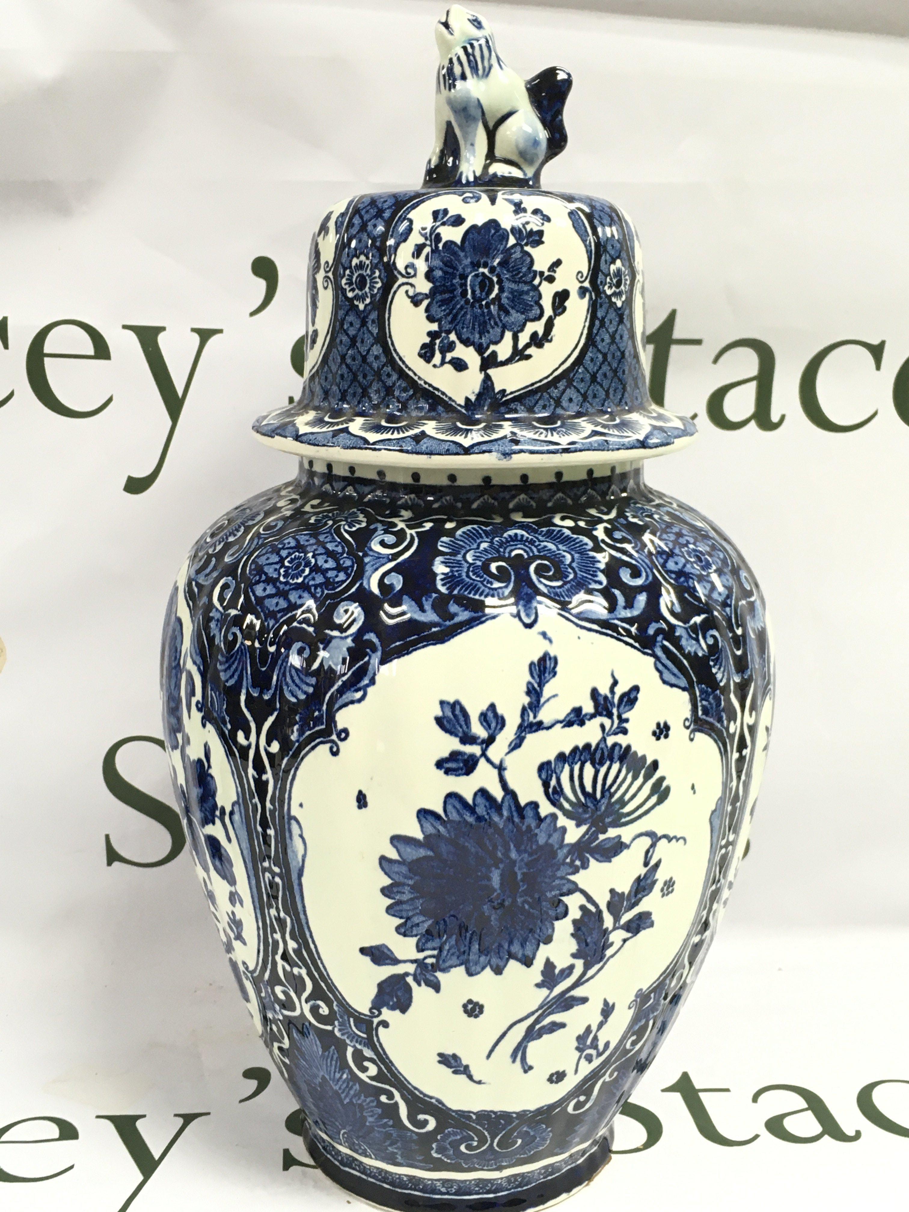 An early 20th century Dutch delft blue and white vase and cover made for royal sphinx by Boch. This lot cannot be posted