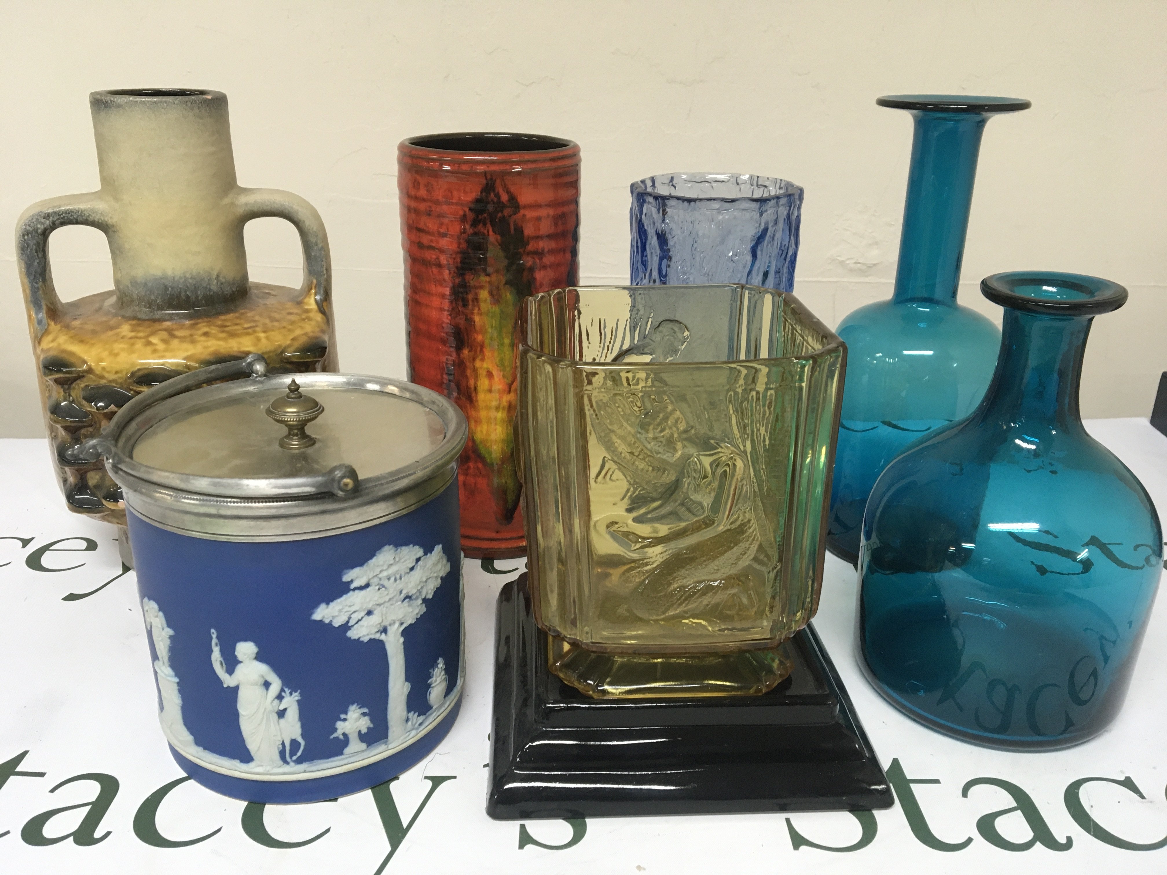 A collection of ceramics and glass an Early 20th century Wedgwood biscuit barrel German pottery mid 20th vase one other glazed pottery vase and art glass.