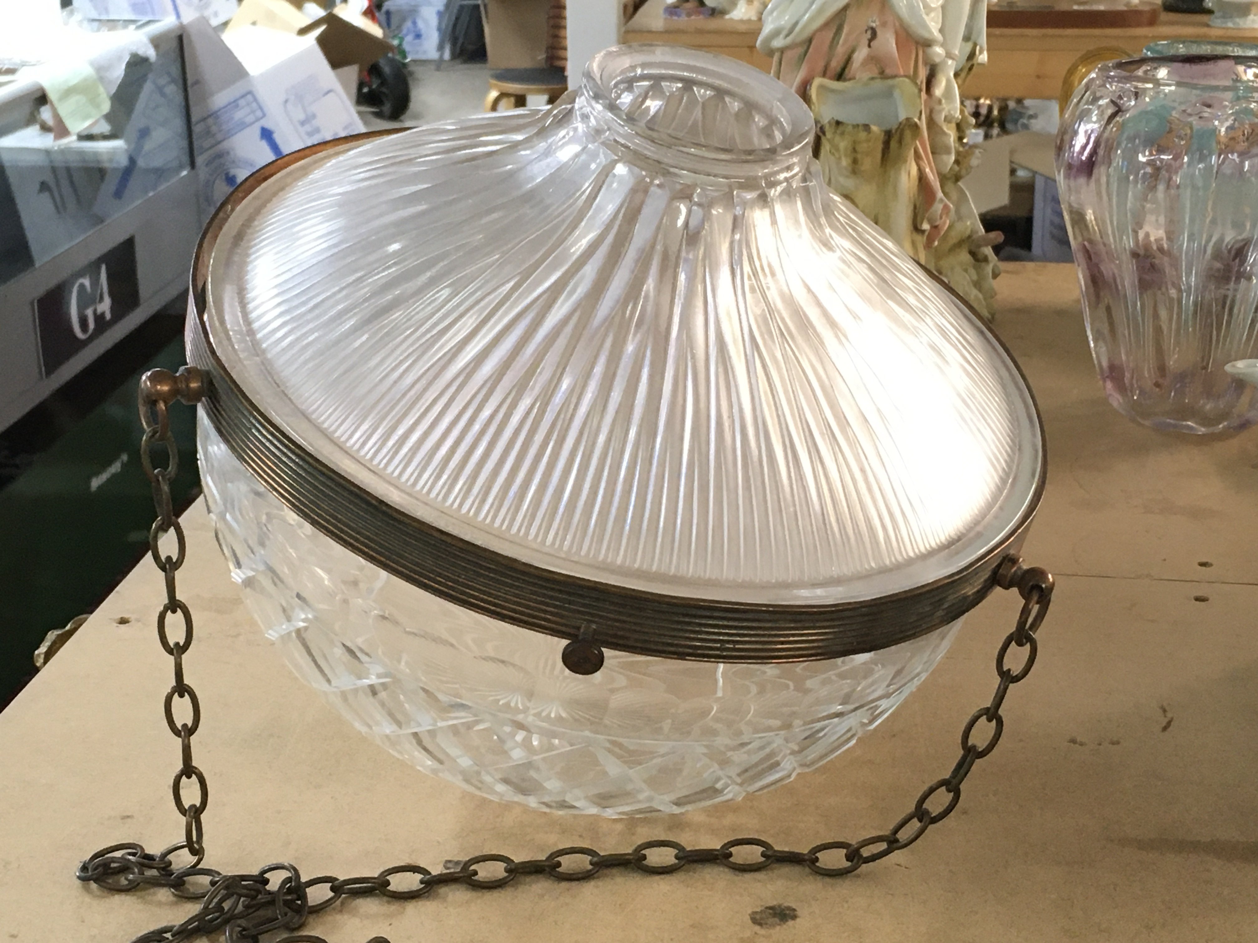 A 1940s cut glass lamp shade with copper finished mounts and chains with additional homophone pressed glass cover. 32cm diameter x 34cm depth. Slight rim chips.