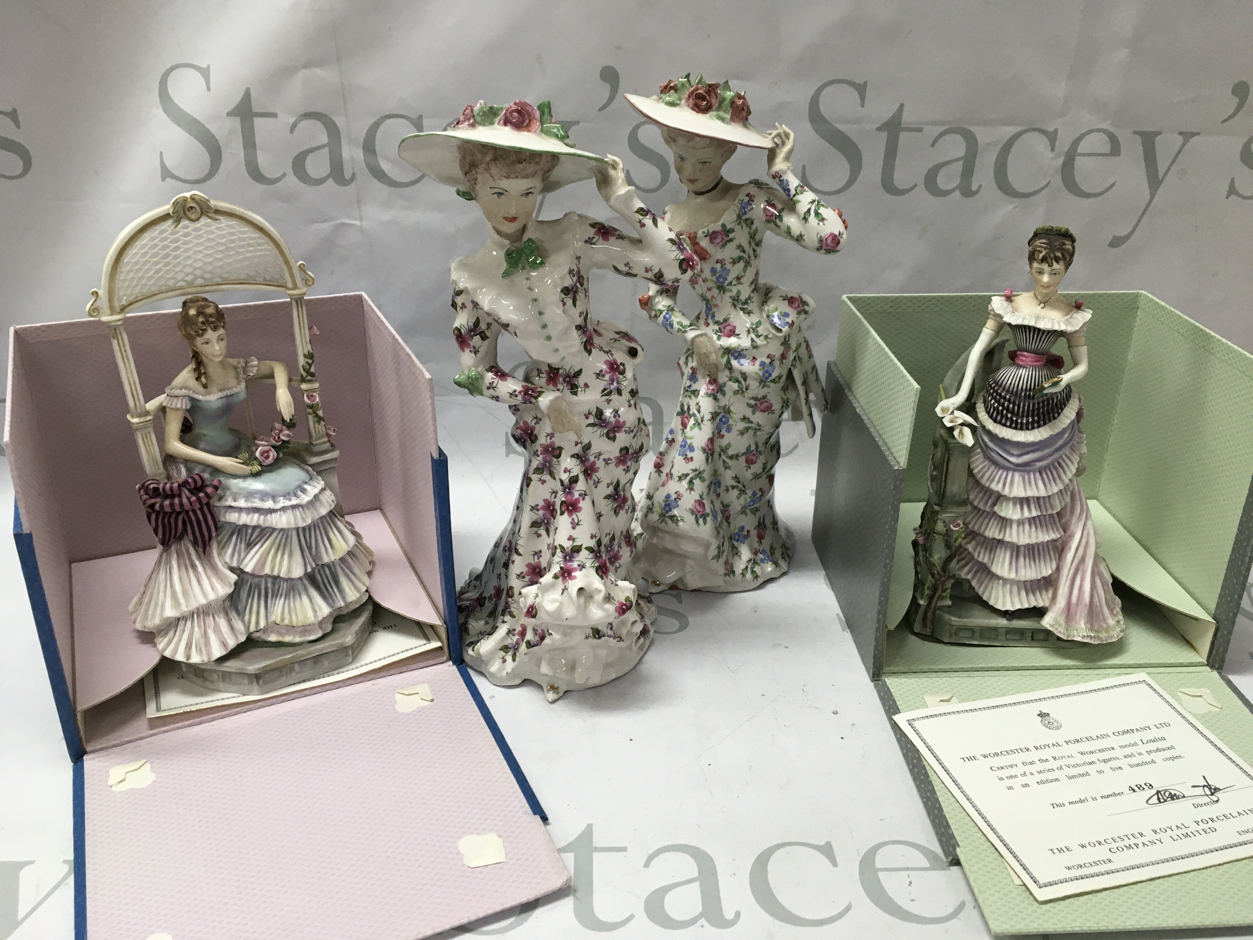 Two worcester lady figures and two other lady figures.