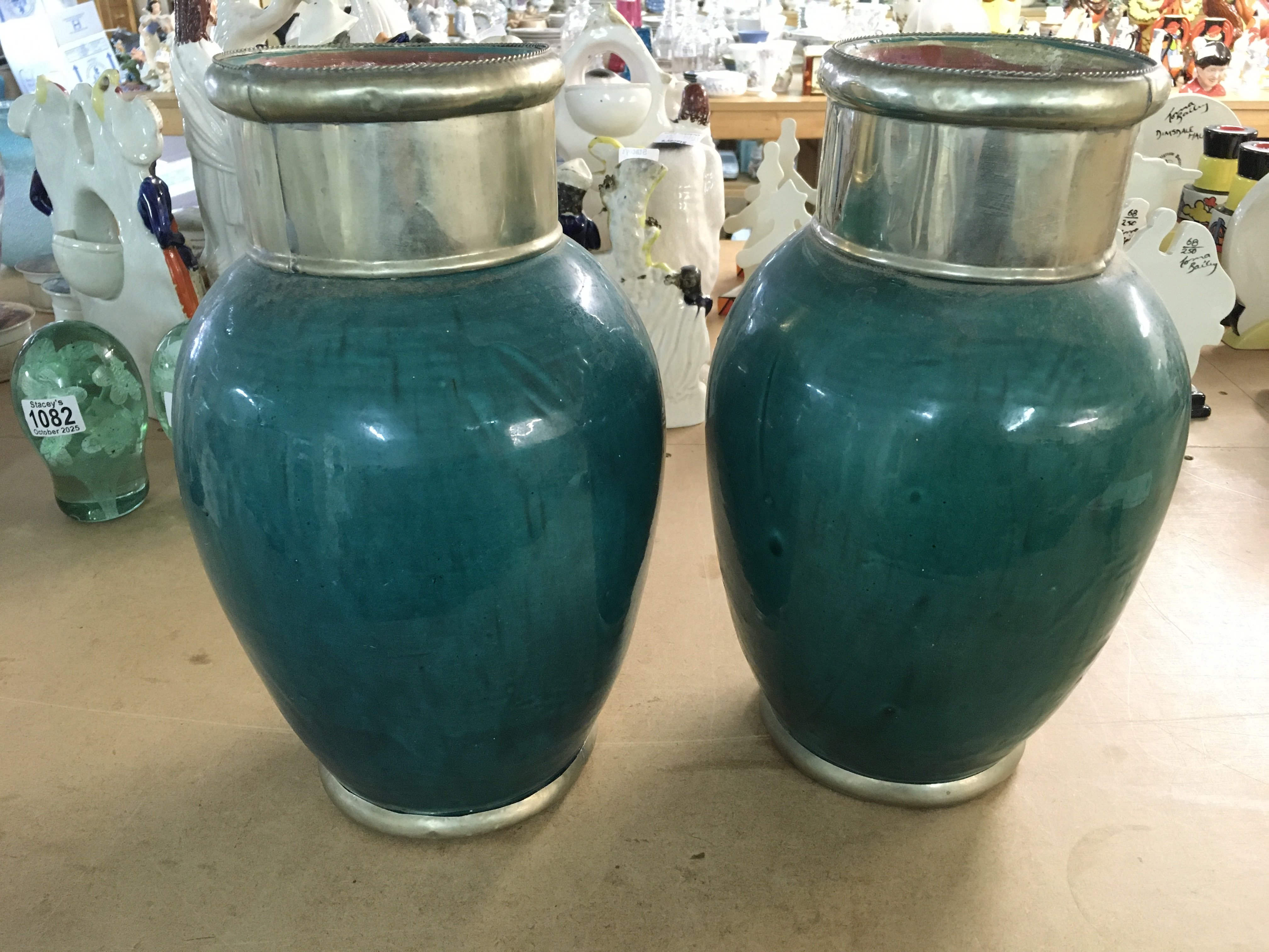 A pair of vases with metal collars. Approximately 13 inches tall