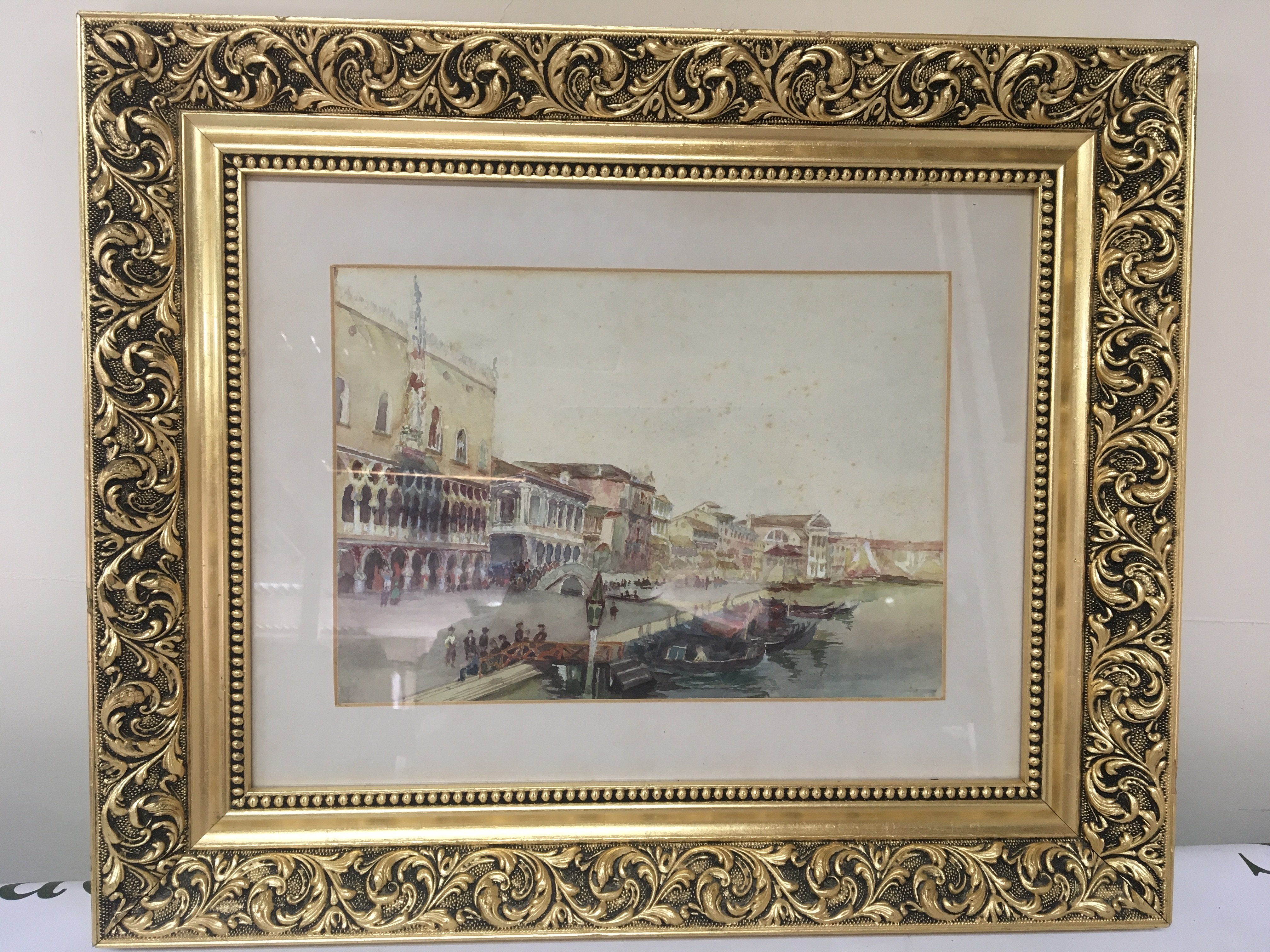 A framed watercolour Venetian scene. With marred gondola and buildings beyond- NO RESERVE