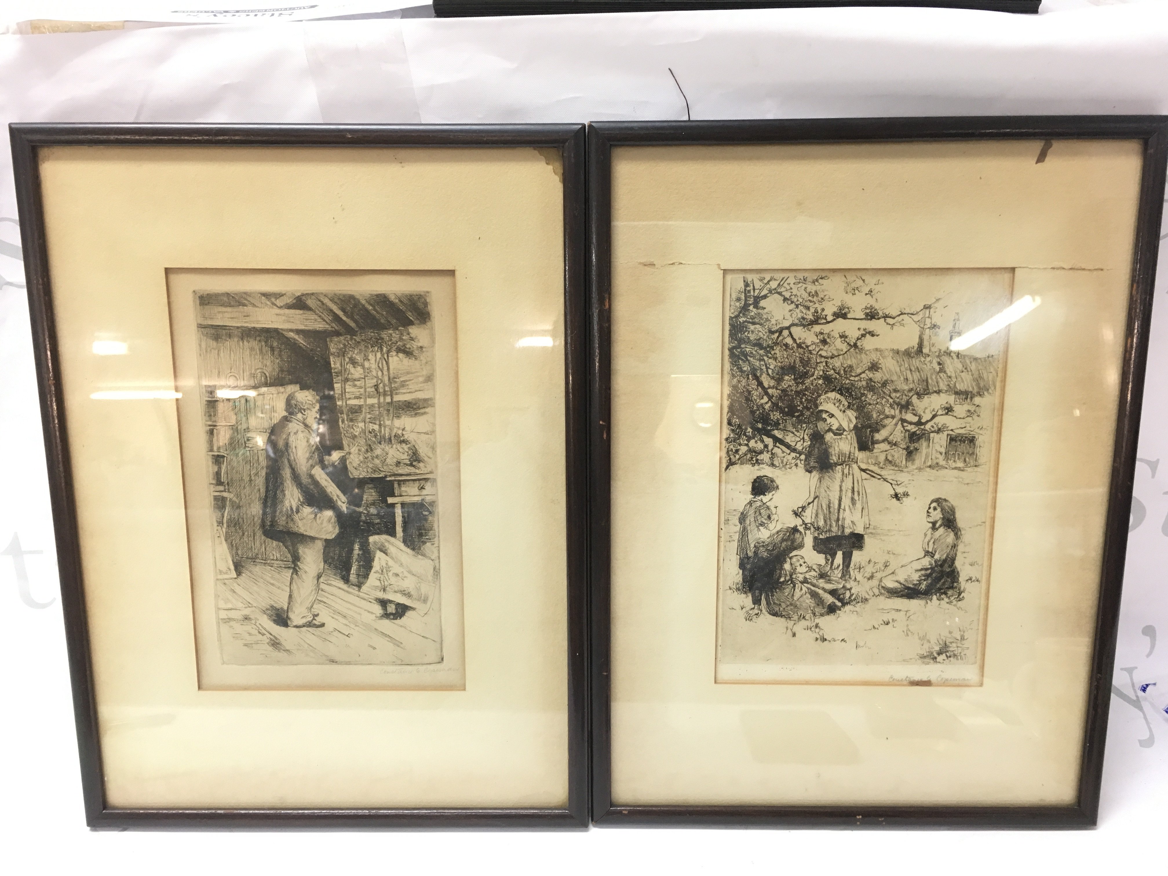 Two framed etchings by Constance G Coleman, one depicting a painter and the other a rural family scene. Frame sizes 29x39cm approximately
