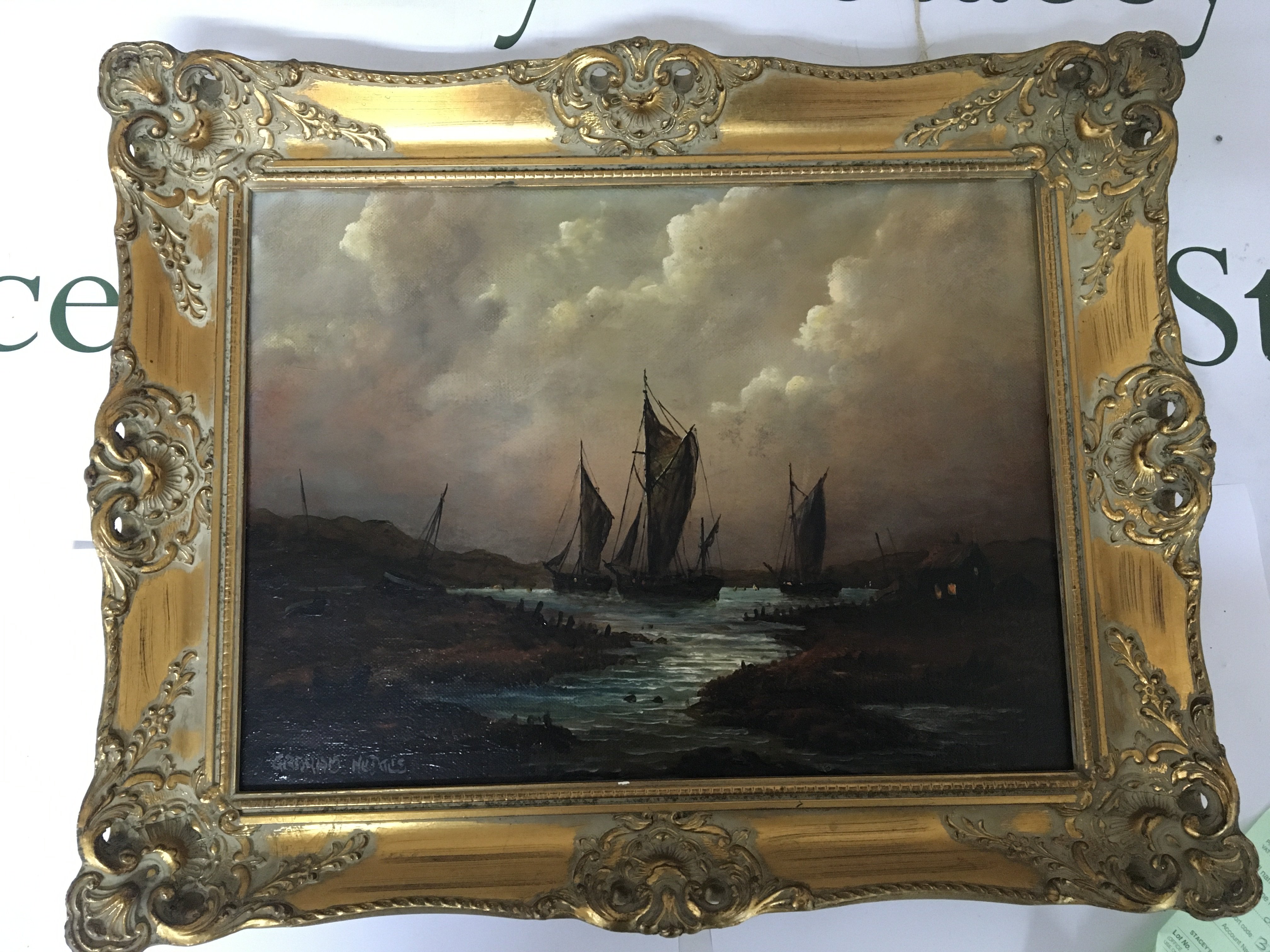 A Gilt framed oil painting on canvas Coastal scene with moored sailing vessels. Signed lower right. 52cmx51cm