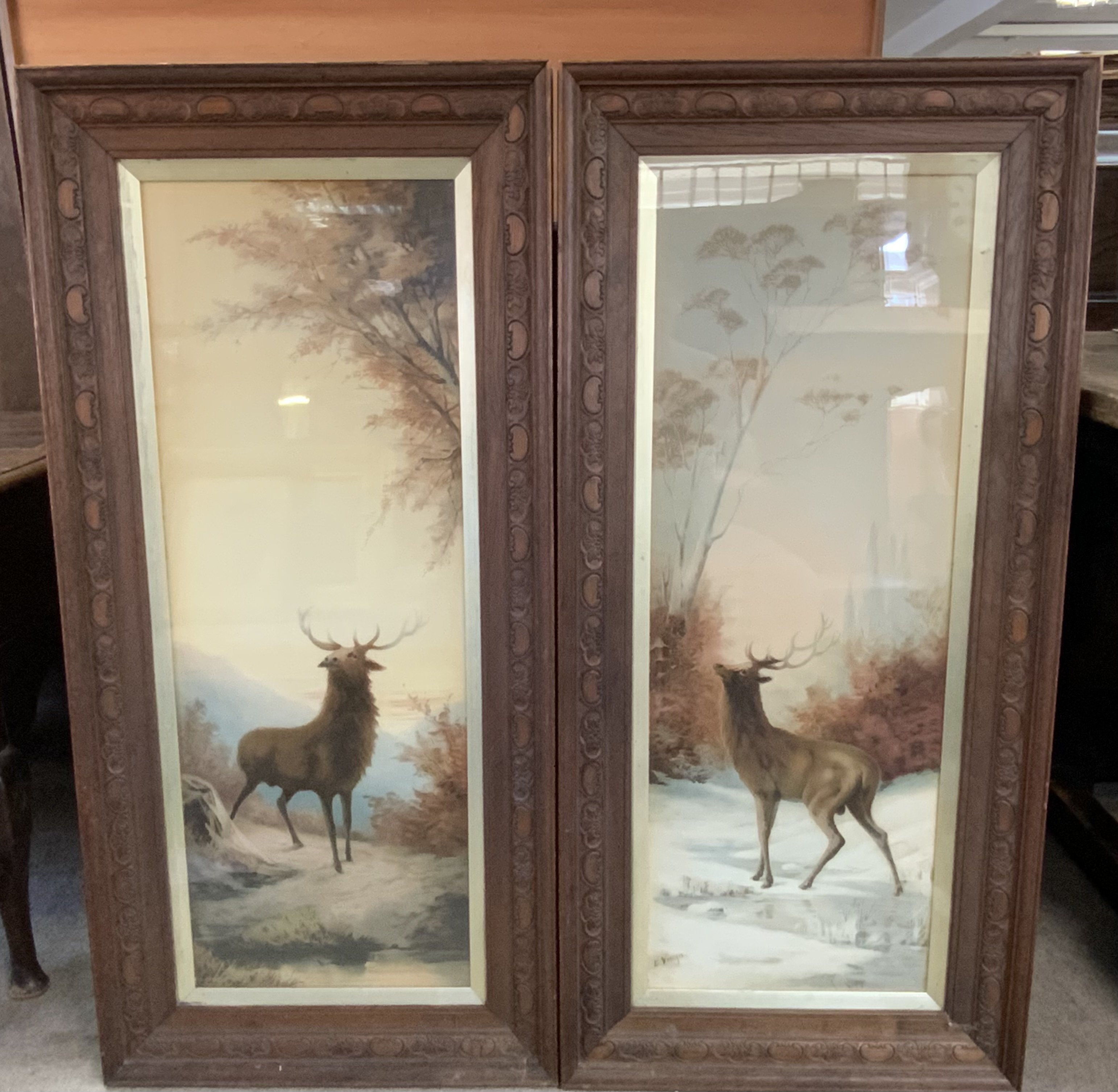 a Pair of opal framed highland Autumn and Winter stag scenes. 112cm x 53cm.