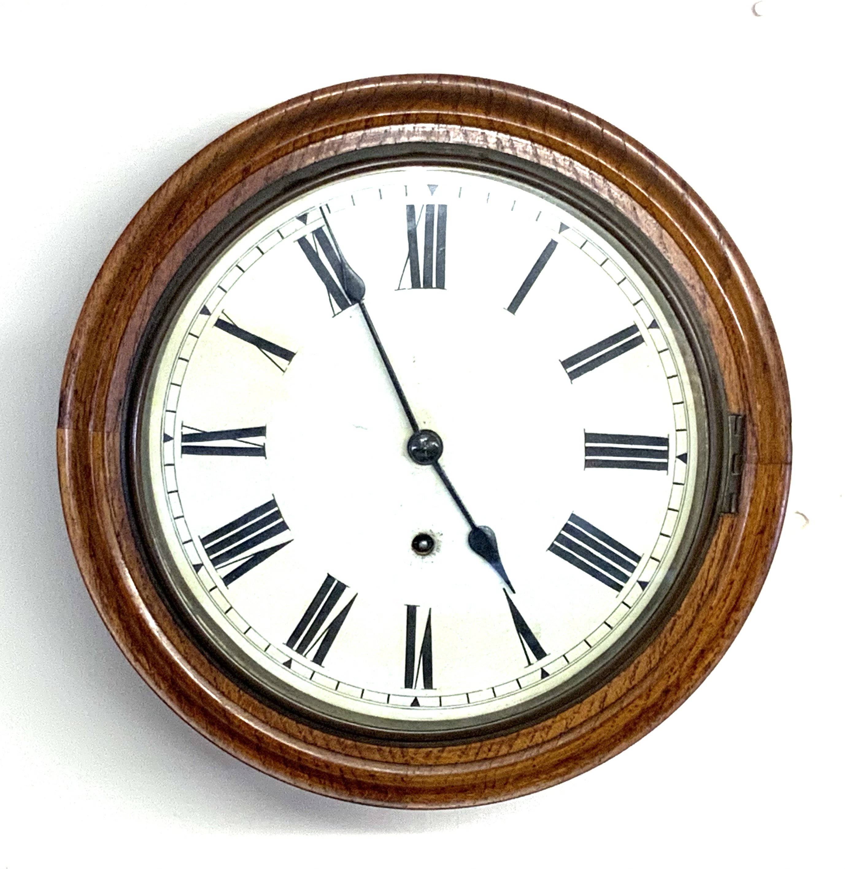 A small oak cased wall clock. 33cm diameter.