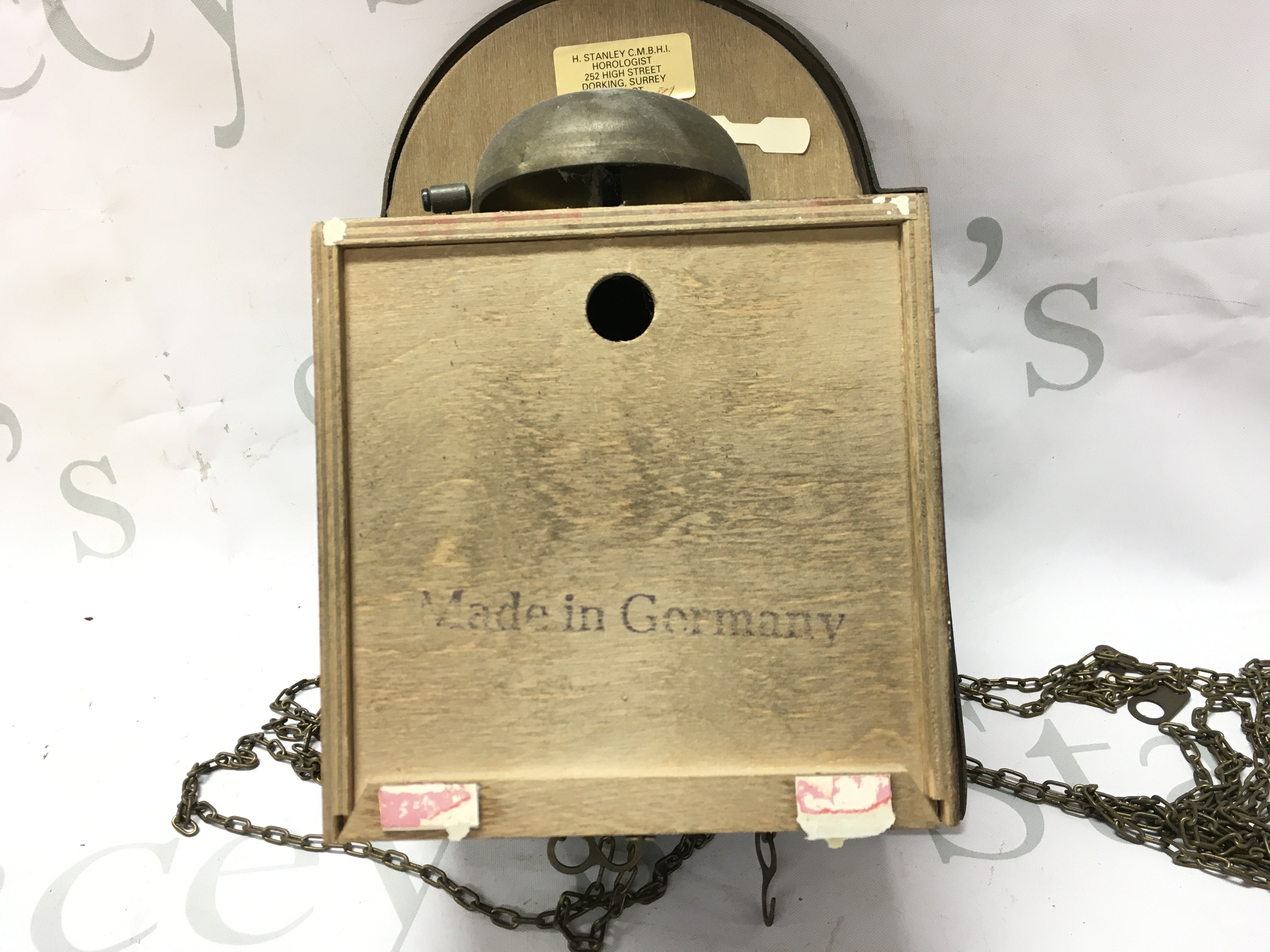 A German brass wall clock with weights . Postage category C- NO RESERVE