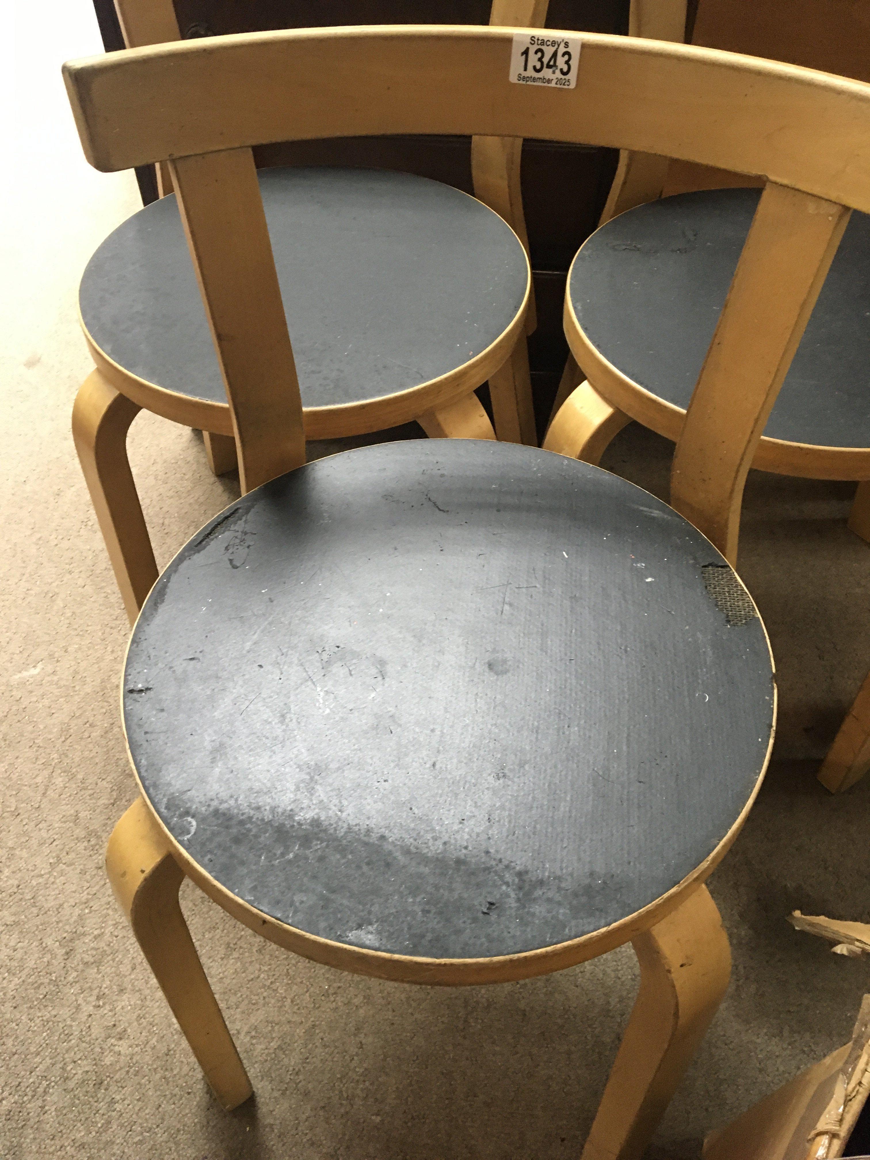 A set of four Alvar Aalto chairs .