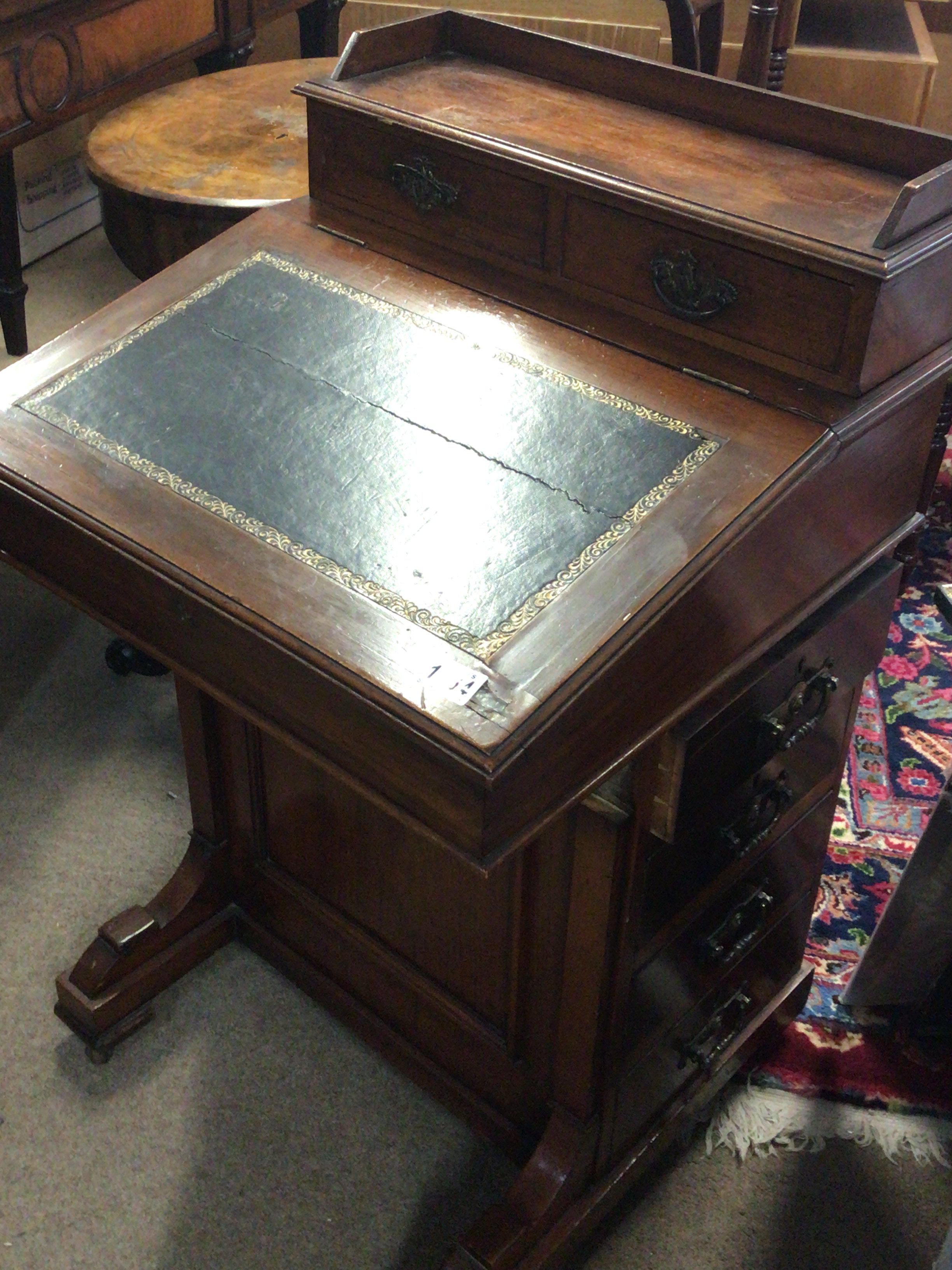 An Edwardian walnut Davenport with a hinged sloping top the sides with a flight of drawers.- NO RESERVE