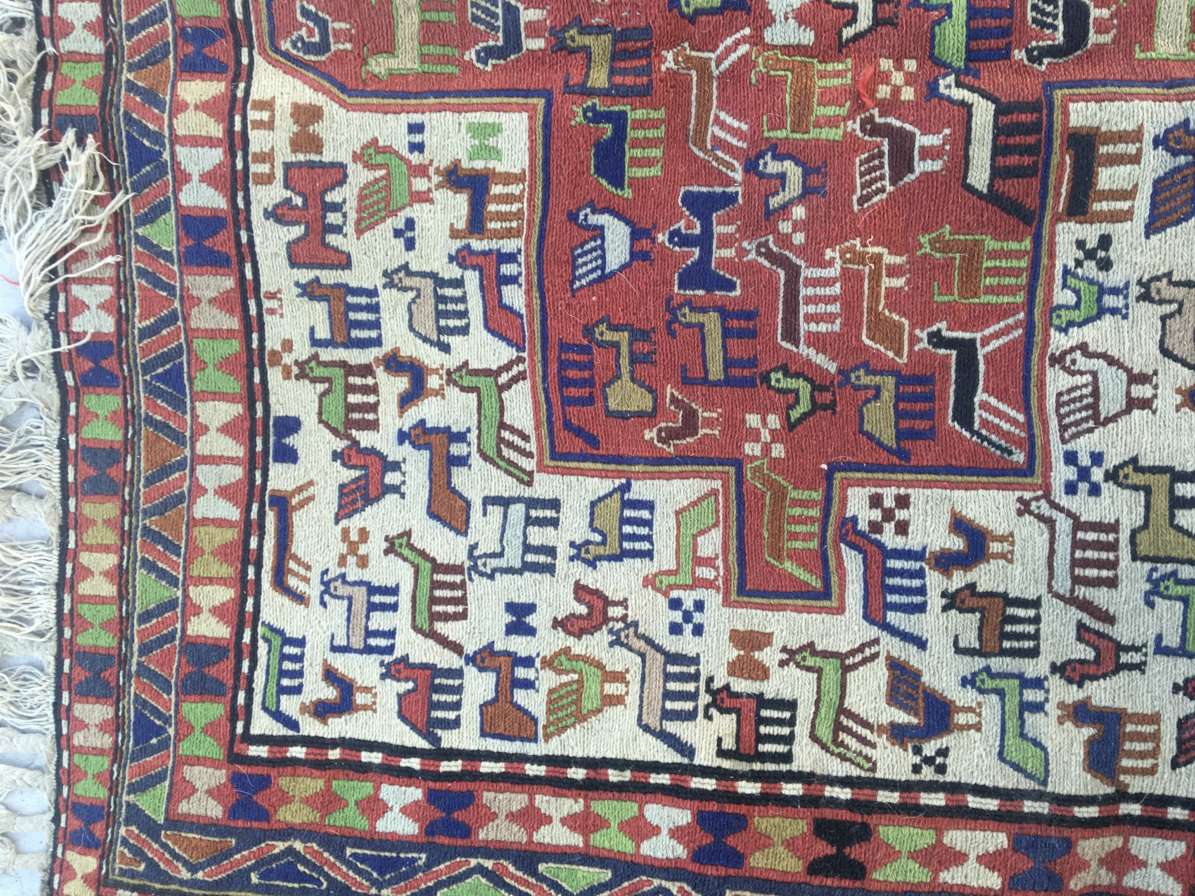 A Soumak rug the central field with Animal design and repeat pattern boarder . 140 x 116 cm .- NO RESERVE